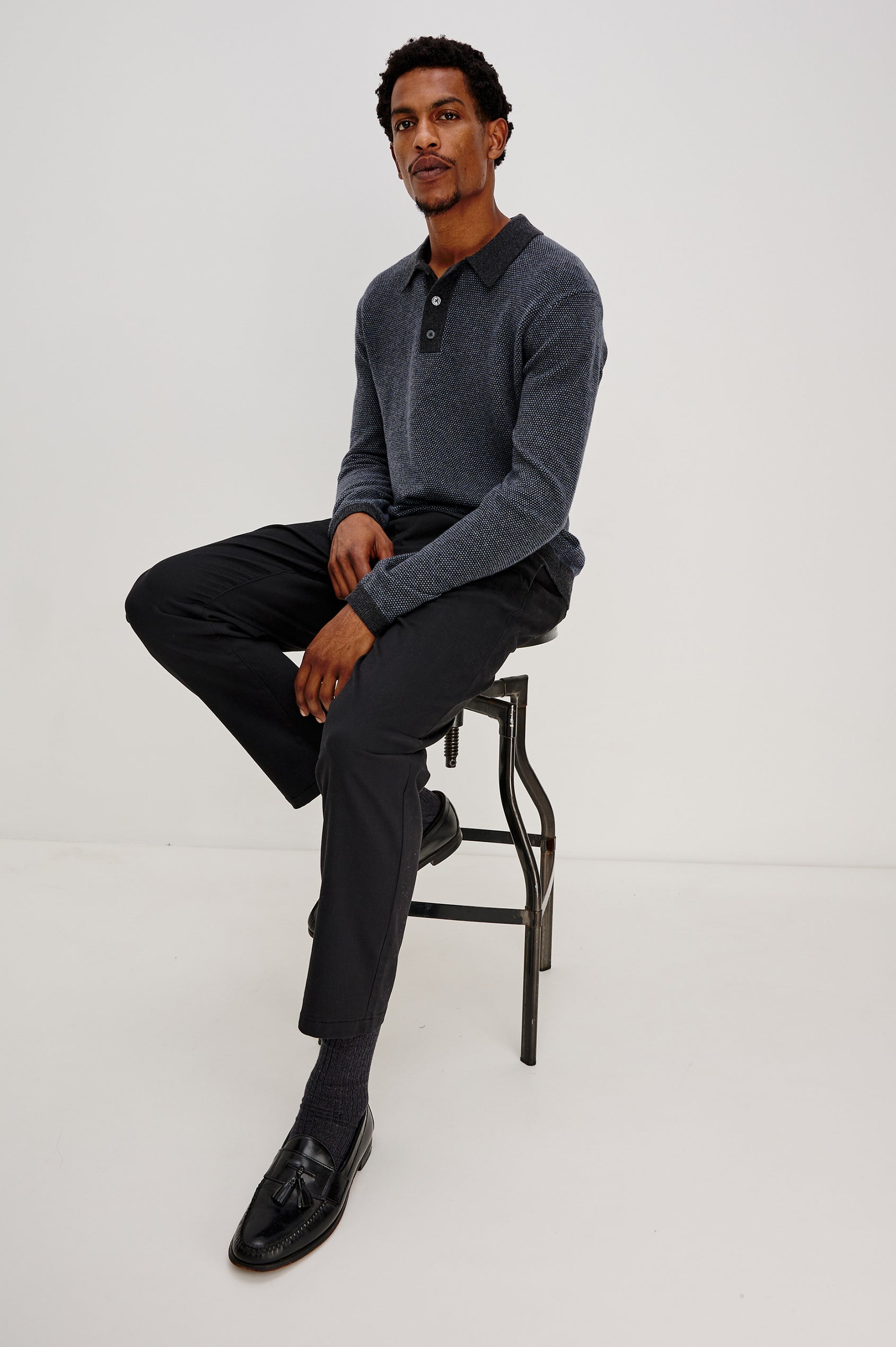 Anders Long Sleeve 3-Button Polo with Contrast Collar, Button Placket, Hem and Cuffs in Navy Blue Colorway. Front Full Body Seated View Featured on Model.