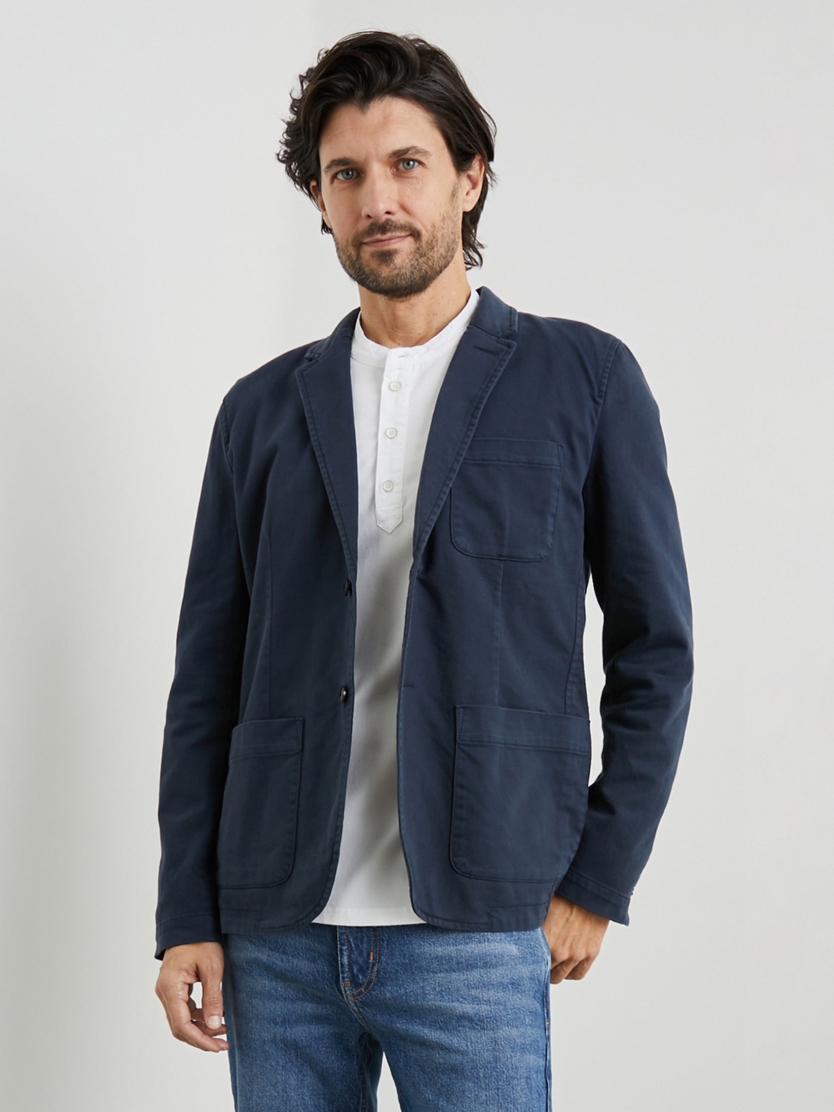 Andre Blazer with Two Button Closure, Two Front Patch Pockets, a Chest Patch Pocket and Three-Button Cuffs in Rugged Navy Twill Colorway - Front View Featured on Model