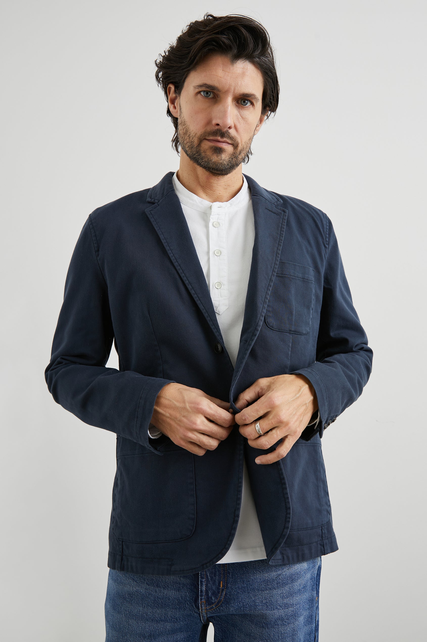 Andre Blazer with Two Button Closure, Two Front Patch Pockets, a Chest Patch Pocket and Three-Button Cuffs in Rugged Navy Twill Colorway - Front View Featured on Model