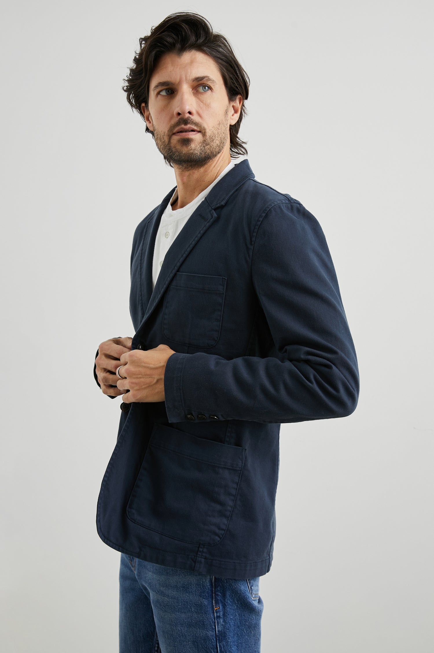 Andre Blazer with Two Button Closure, Two Front Patch Pockets, a Chest Patch Pocket and Three-Button Cuffs in Rugged Navy Twill Colorway - Front View Featured on Model