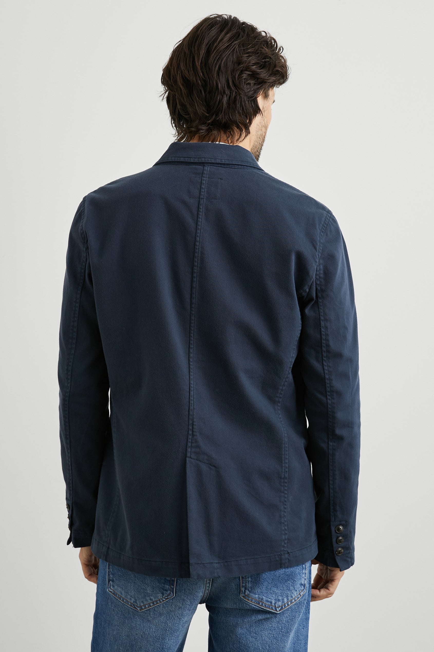 Andre Blazer with Two Button Closure, Two Front Patch Pockets, a Chest Patch Pocket and Three-Button Cuffs in Rugged Navy Twill Colorway - Back View Featured on Model