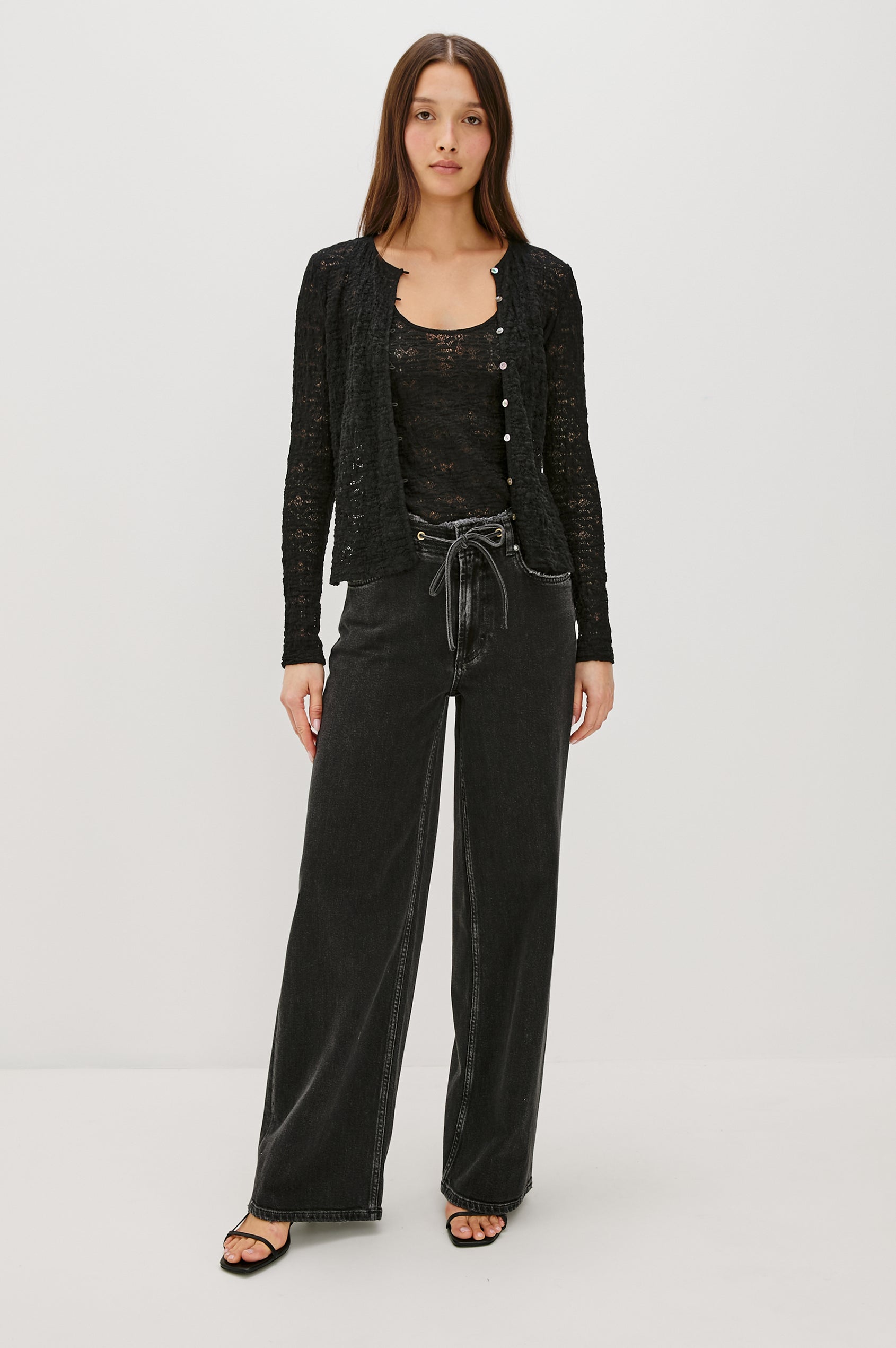 Angeleno mid rise slouchy wide leg jean with a drawstring waist tie, gromets and a raw edge waistband in a black wash Ash Black - front full body view featured on model.