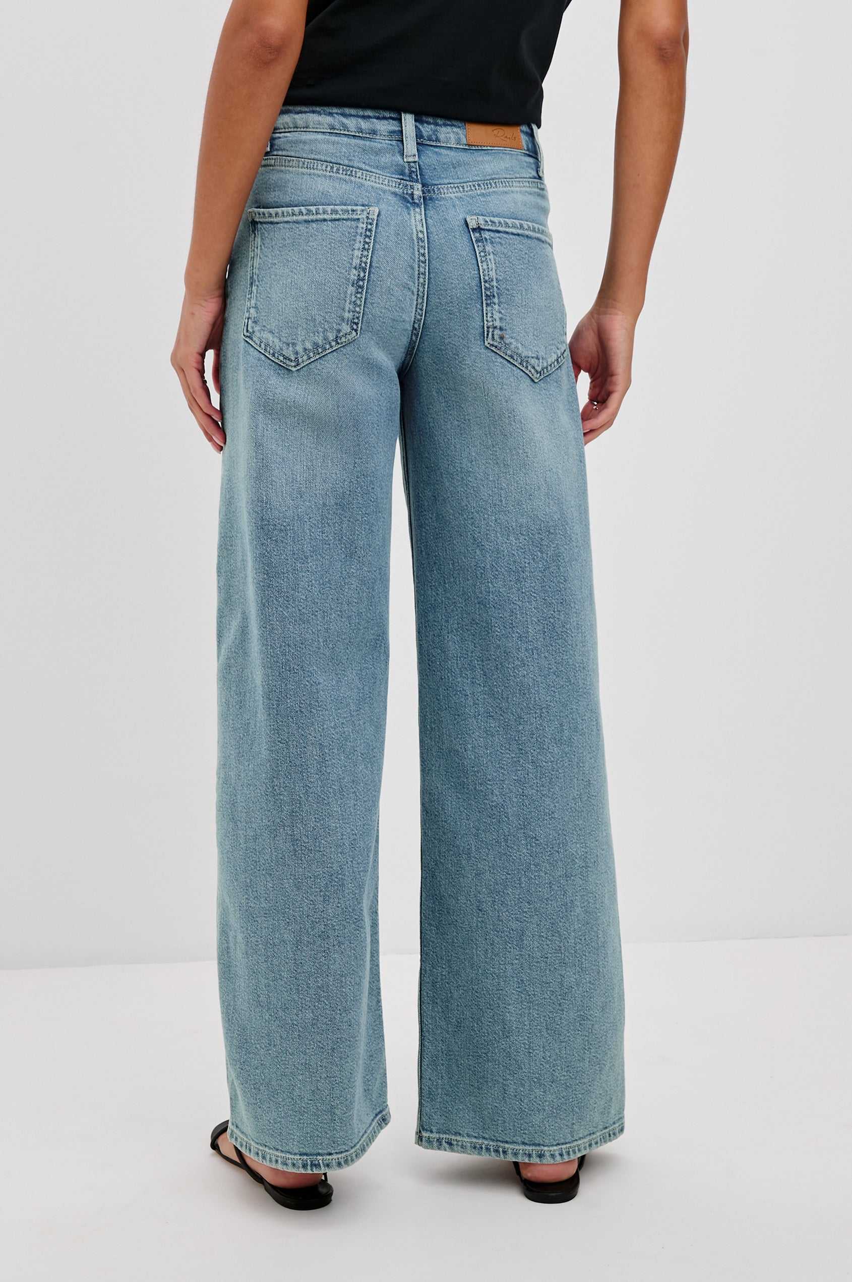 Angeleno mid right slouchy wide leg jean in light wash Blue Eyed Girl - back view on model