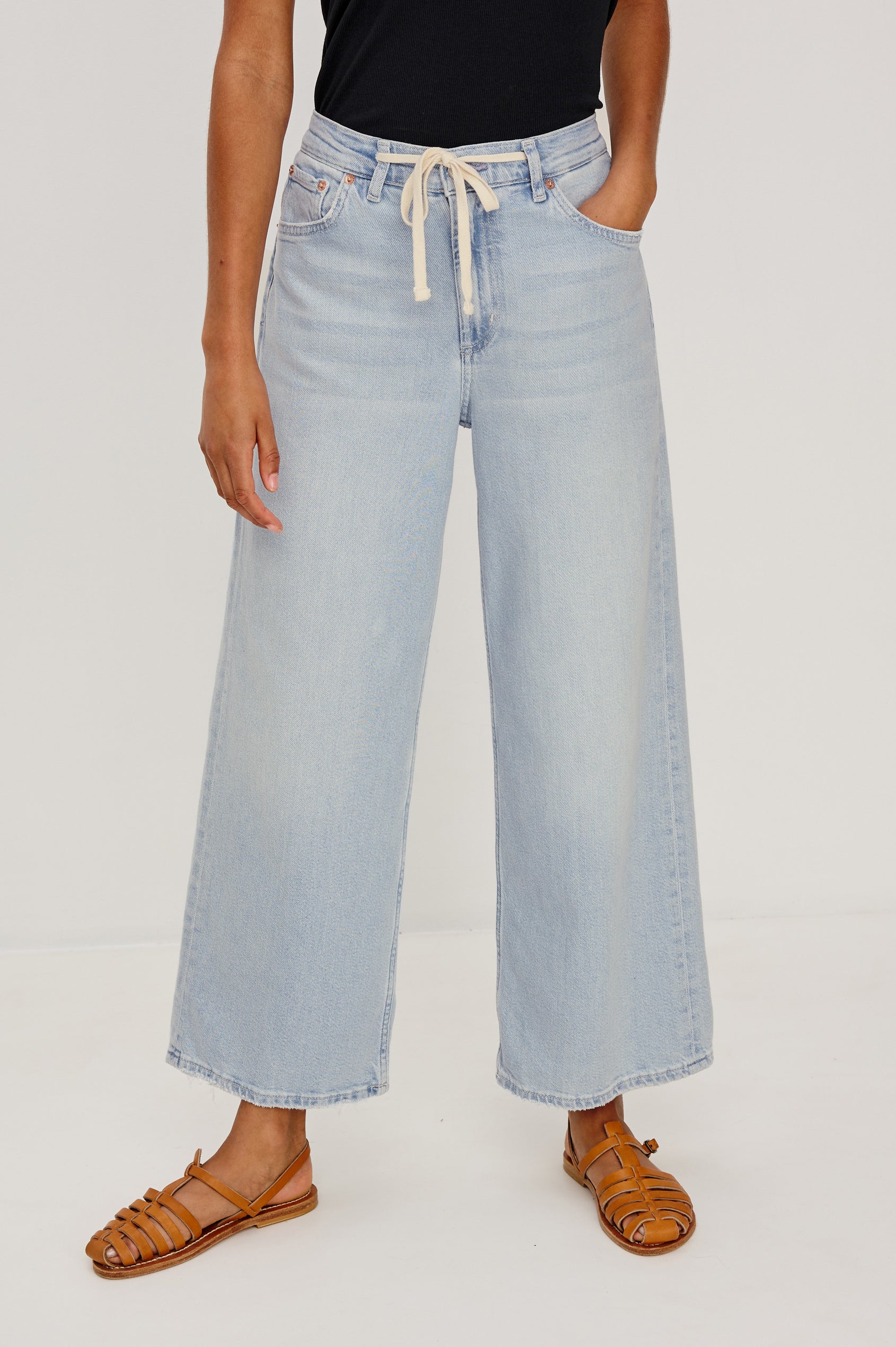Angeleno Crop Denim Pant, Wide Leg, Five Pocket Zip Fly with a White Drawstring Tie at Waist in Light Wash Scuba Colorway. Front View Shown on Model.