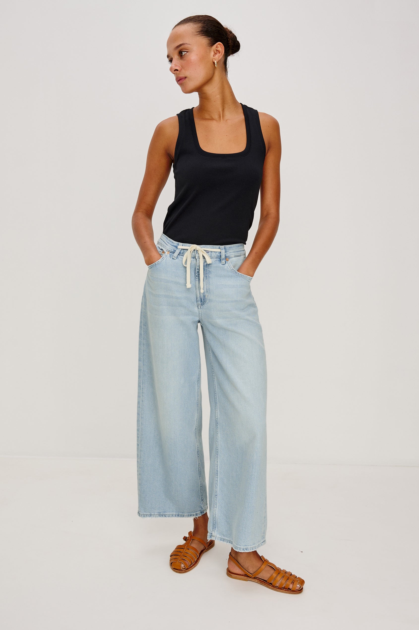 Angeleno Crop Denim Pant, Wide Leg, Five Pocket Zip Fly with a White Drawstring Tie at Waist in Light Wash Scuba Colorway. Front View Shown on Model.