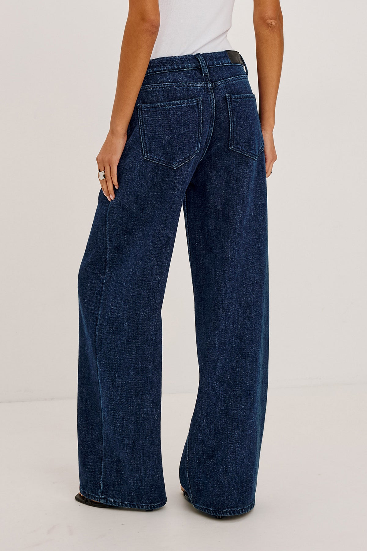 Angeleno Wide Leg Jean With Mid-Rise Relaxed Fit, Wide Legs, Drawstring Waist Ties, Hidden Stretch, and 5-Pockets in Imperial Blue Colorway - Lower Body Back View Featured on Model