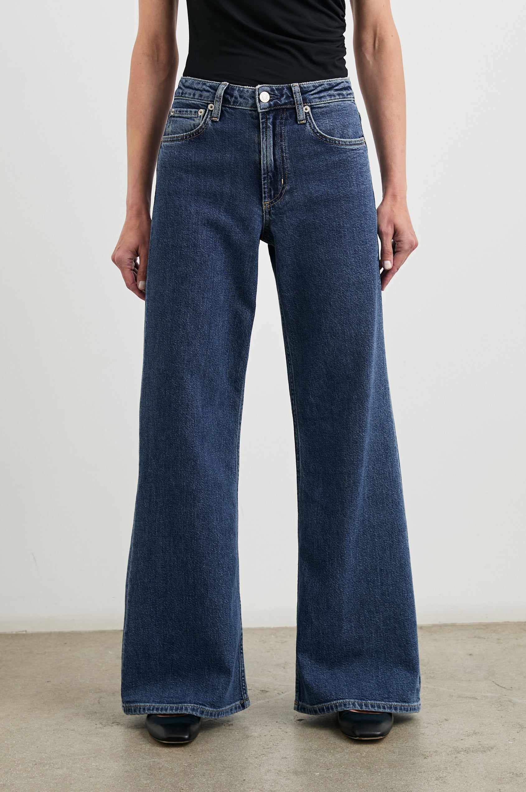 Angeleno Wide Leg Denim Pants with Belt Loops, Two Front Pockets and Two Back Patch Pockets in Pebble Blue Colorway - Front View Featured on Model