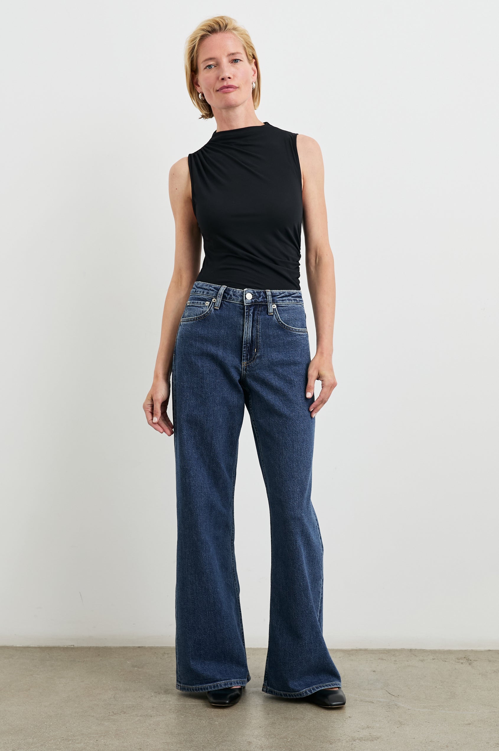 Angeleno Wide Leg Denim Pants with Belt Loops, Two Front Pockets and Two Back Patch Pockets in Pebble Blue Colorway - Front Full Body View Featured on Model