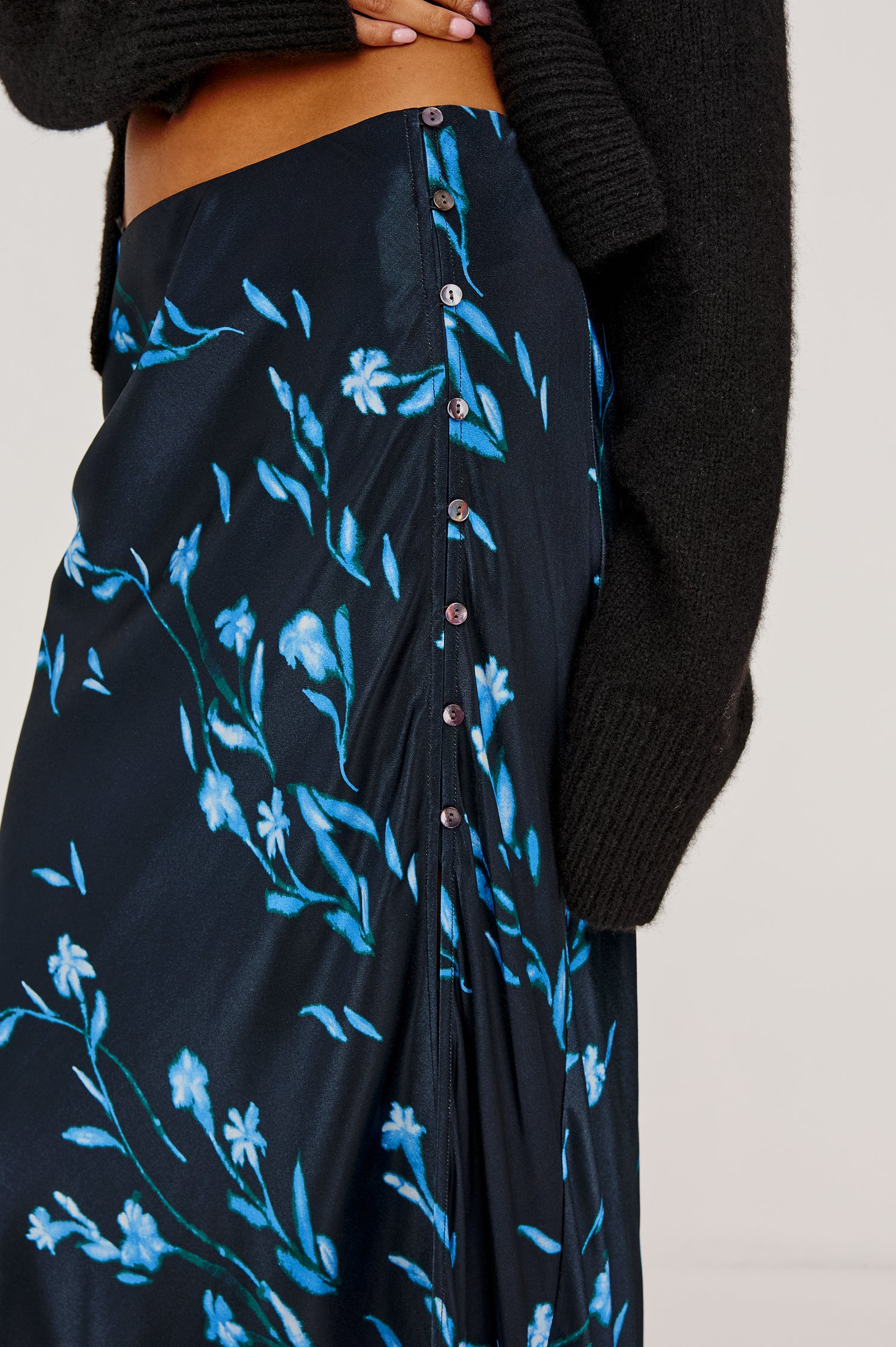 Anya High-Waisted Midi Skirt in Satin Crepe With Side Slit in Blue Carnation Floral Print- Close Up Mid Body View Featured on Model