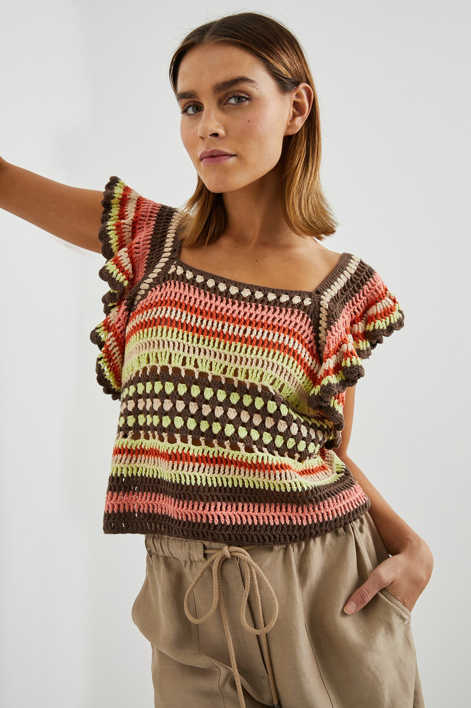Anna Short Sleeve Crochet Top with Flared Sleeves and a Square Neck in Tropical Crochet Colorway, in Orange, Pink, Green, Brown, and White - Front View Featured on Model  