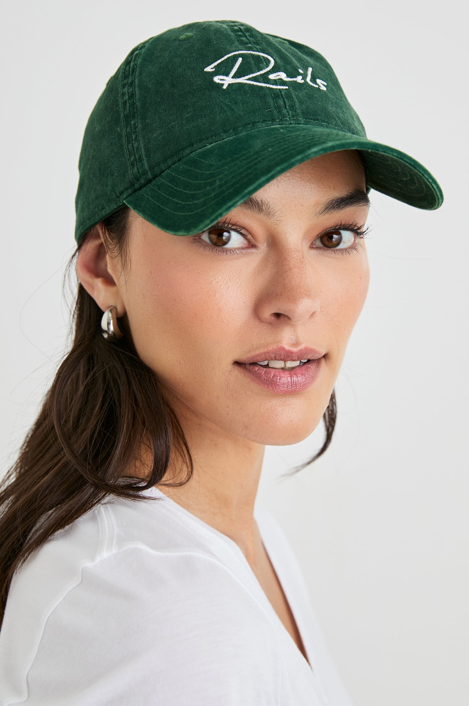 Anniversary Baseball Cap with an Adjustable Back Strap, Front Text, Rails, and Back Text, Est 2009, in Forest Colorway, with White Text - Front View Featured on Model