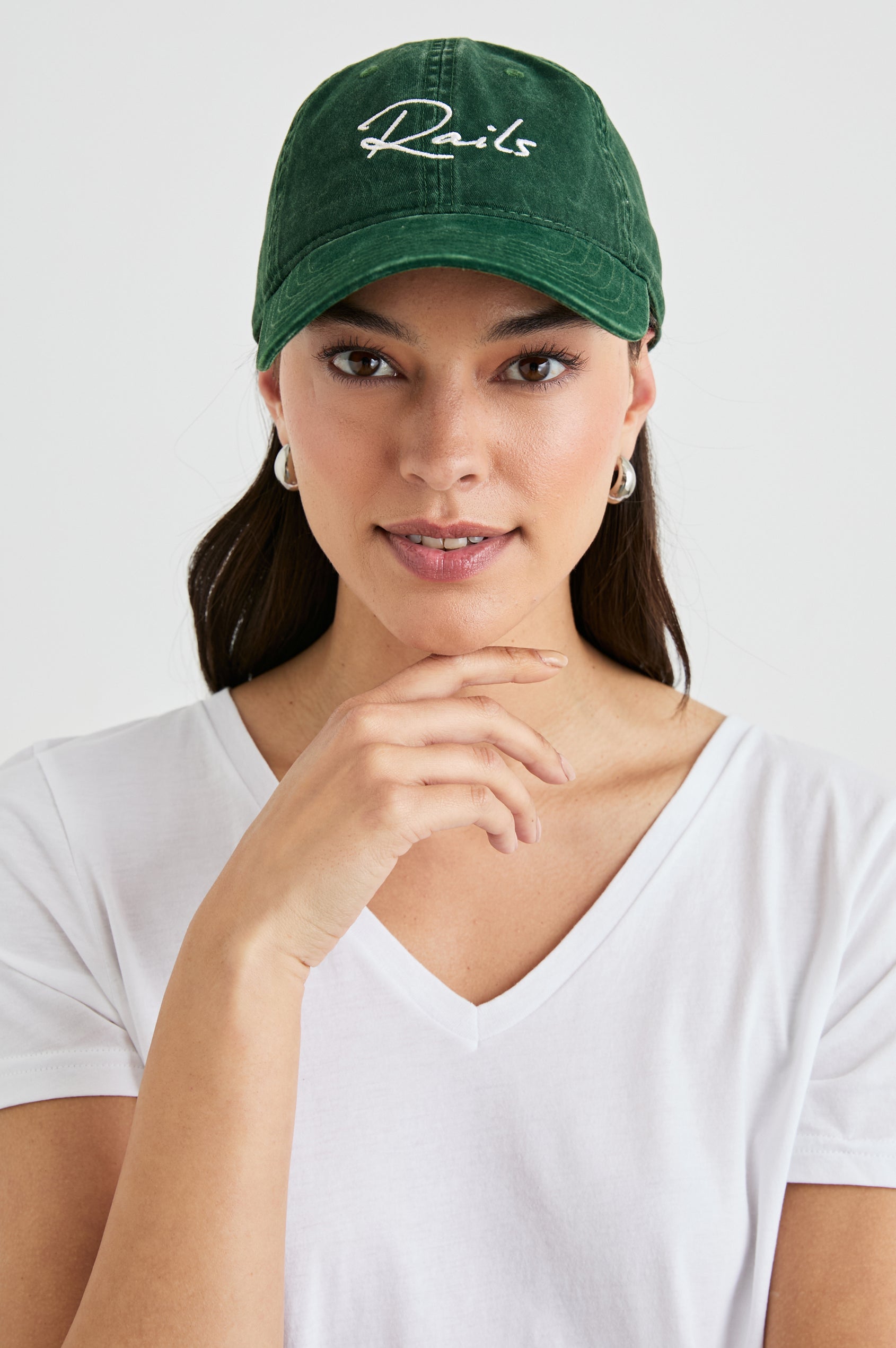 Anniversary Baseball Cap with an Adjustable Back Strap, Front Text, Rails, and Back Text, Est 2009, in Forest Colorway, with White Text - Front View Featured on Model