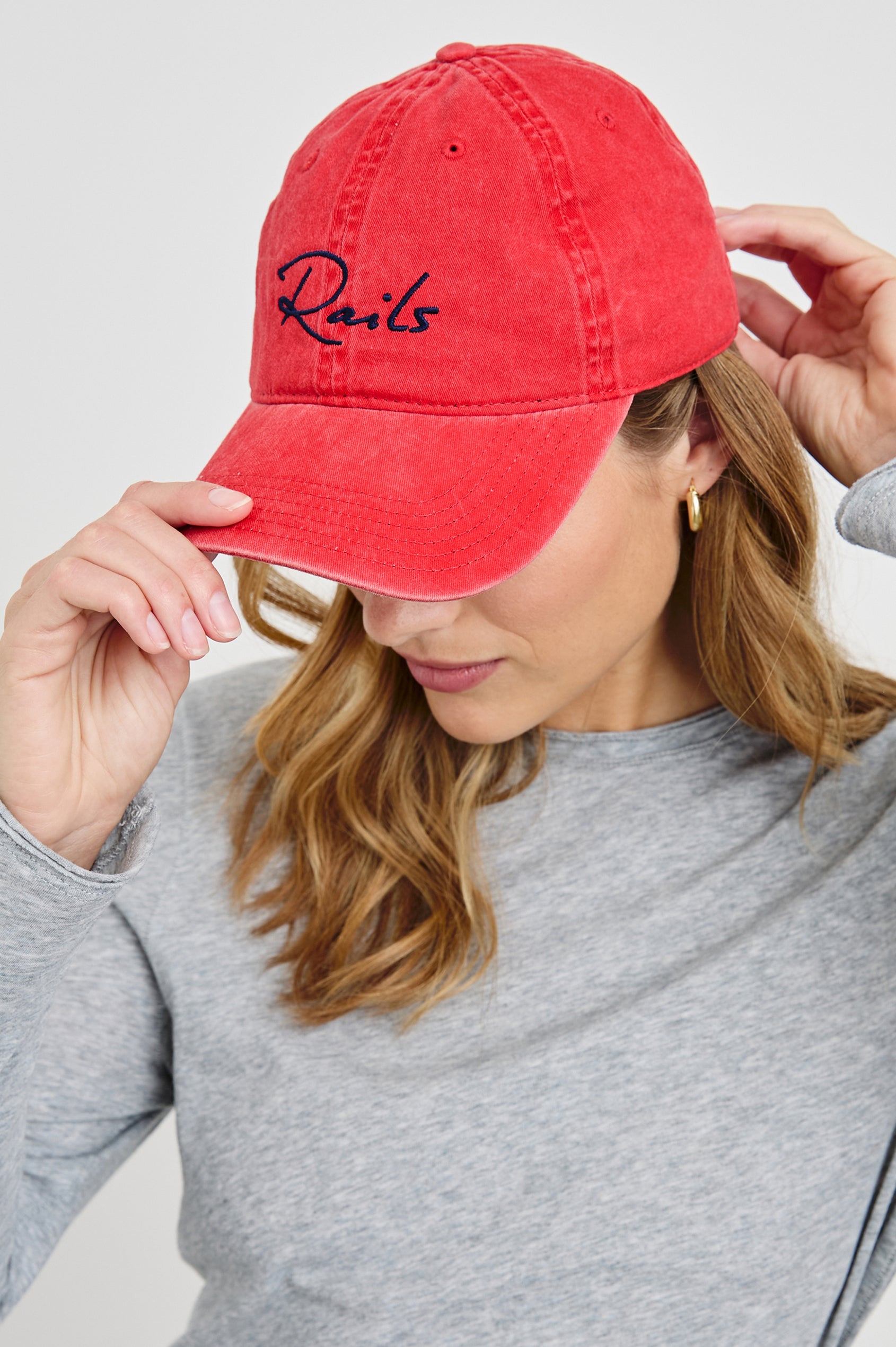 Anniversary Baseball Cap with an Adjustable Back Strap, Front Text, Rails, and Back Text, Est 2009, in Washed Red Colorway, with Blue Text - Front View Featured on Model