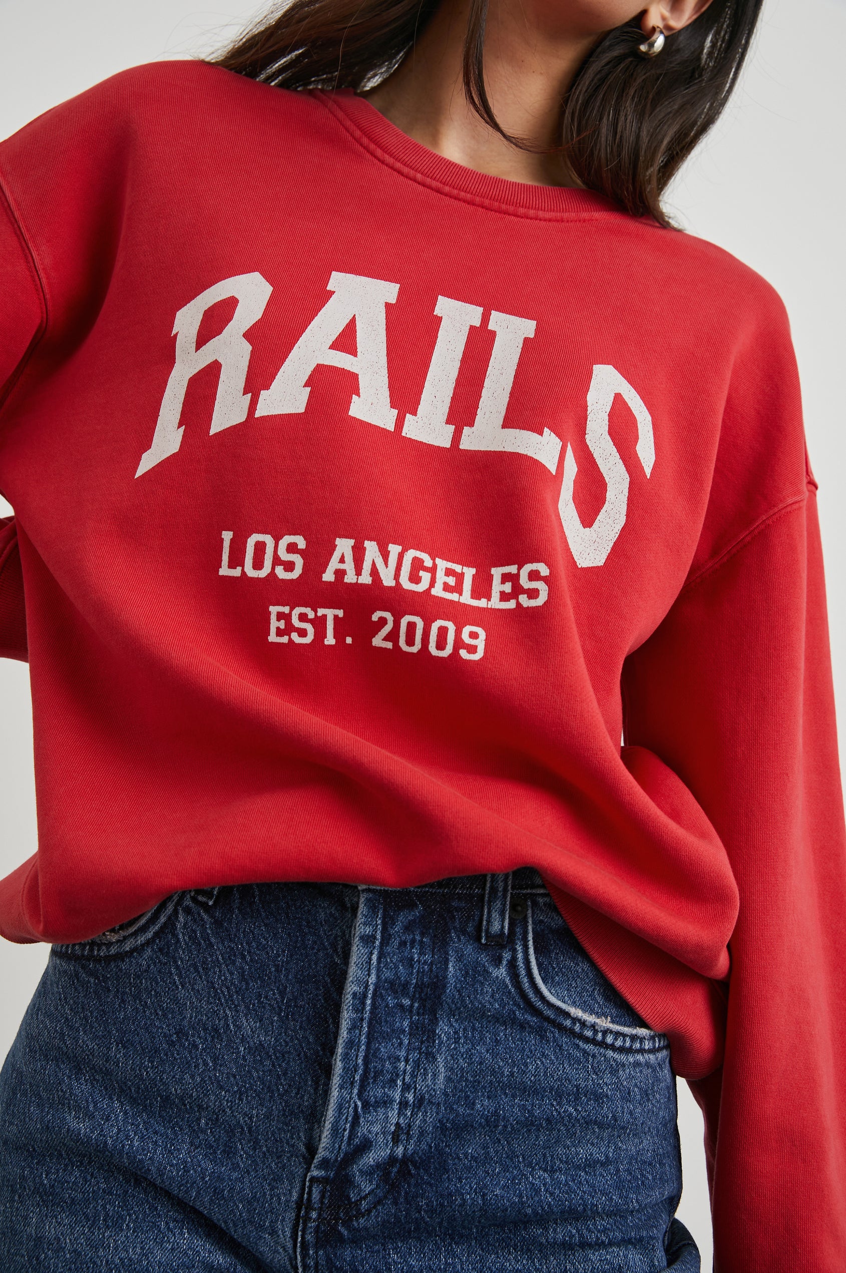 Anniversary Sweatshirt with Crewneck, Text States, Rails Los Angeles Est 2009, in Washed Red Colorway with White Letters - Front View Featured on Model 