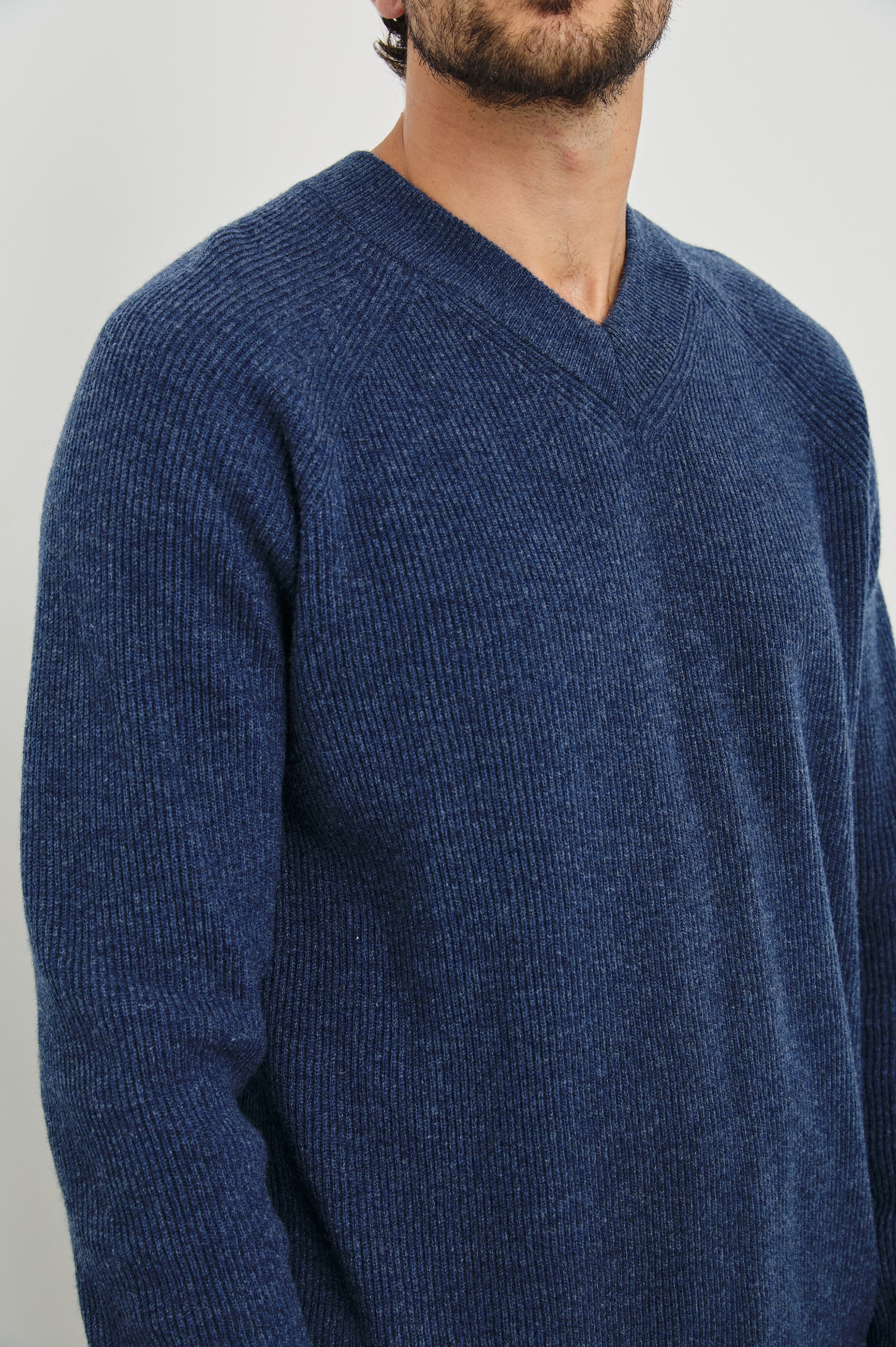 Ansel Long-Sleeve Ribbed Sweater with a V-neck in Blue Melange Colorway - Front View Featured on Model