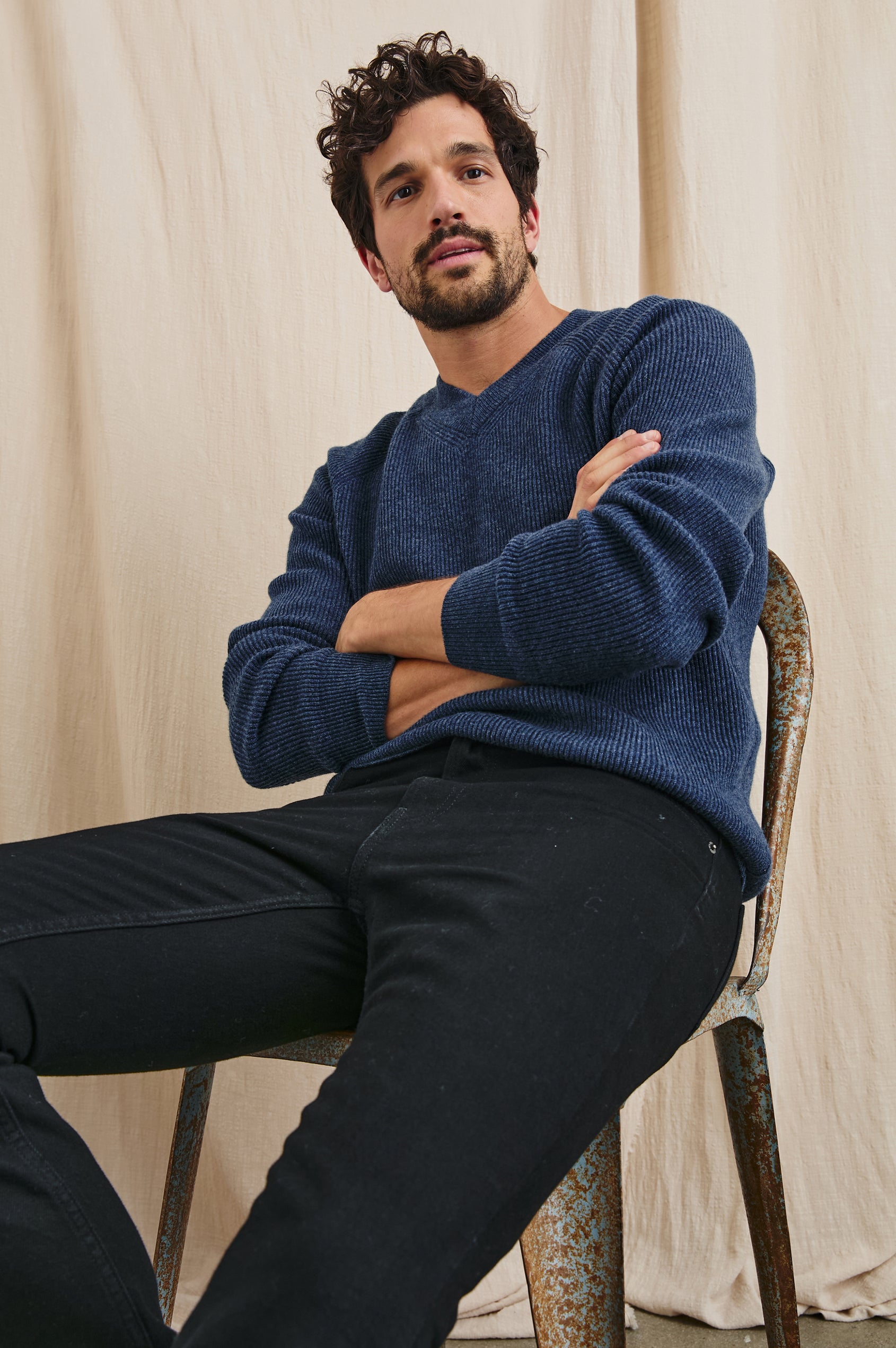 Ansel Long-Sleeve Ribbed Sweater with a V-neck in Blue Melange Colorway - Front Full Body View Featured on Seated Model