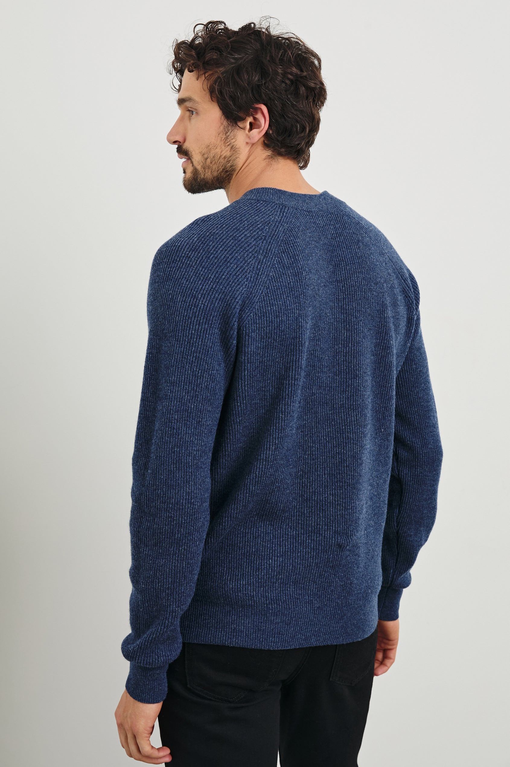 Ansel Long-Sleeve Ribbed Sweater with a V-neck in Blue Melange Colorway - Back View Featured on Model