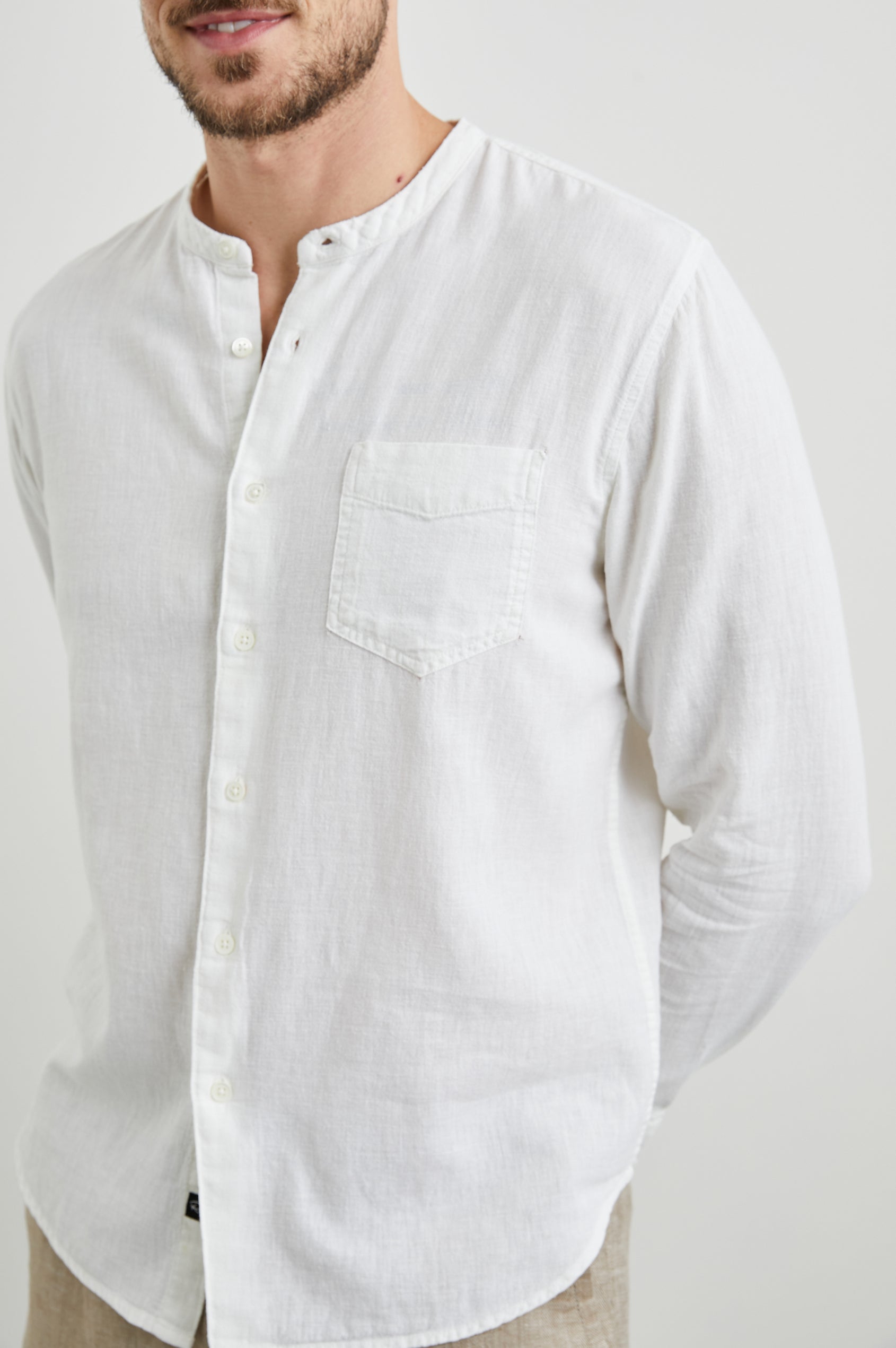 Antoine Long-Sleeve Button Up Without a Collar and with a Chest Patch Pocket in Antique White Colorway - Front View Featured on Model 
