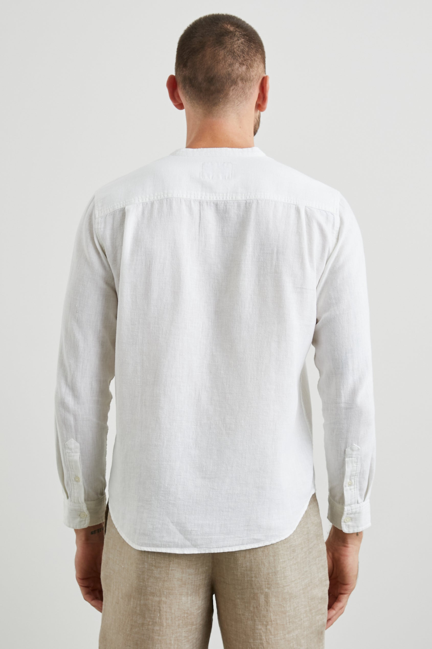 Antoine Long-Sleeve Button Up Without a Collar and with a Chest Patch Pocket in Antique White Colorway - Back View Featured on Model 