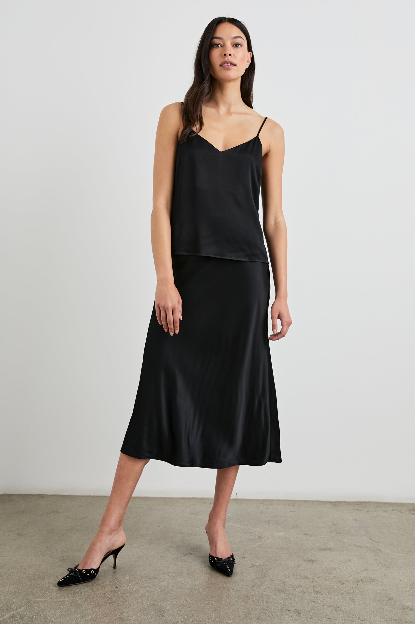 Anya High-waisted Midi Skirt in Black Colorway - Front Full Body View Featured on Model