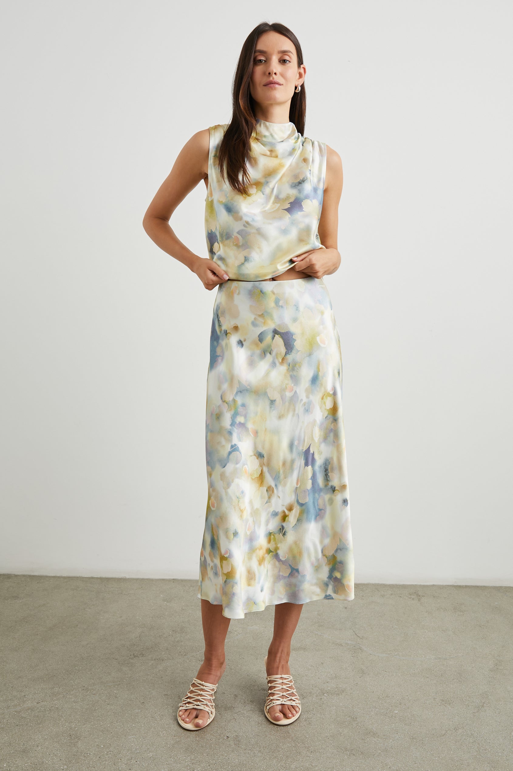 Anya High-waisted Midi Skirt in Diffused Blossom Colorway, with flowers in Creams, Golds and Blues on White - Front Full Body View Featured on Model