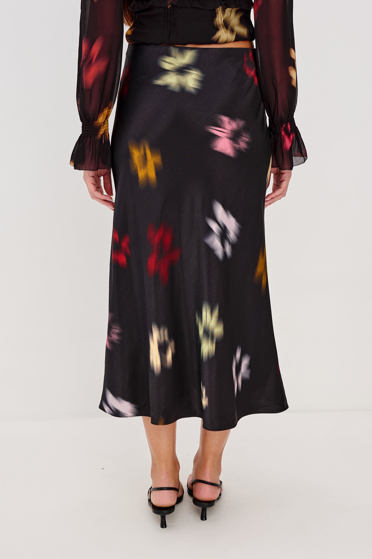 Anya High-Waisted Midi Skirt in Satin Crepe With Side Slit in Blurred Floral Colorway - Lower Body Back View Featured on Model
