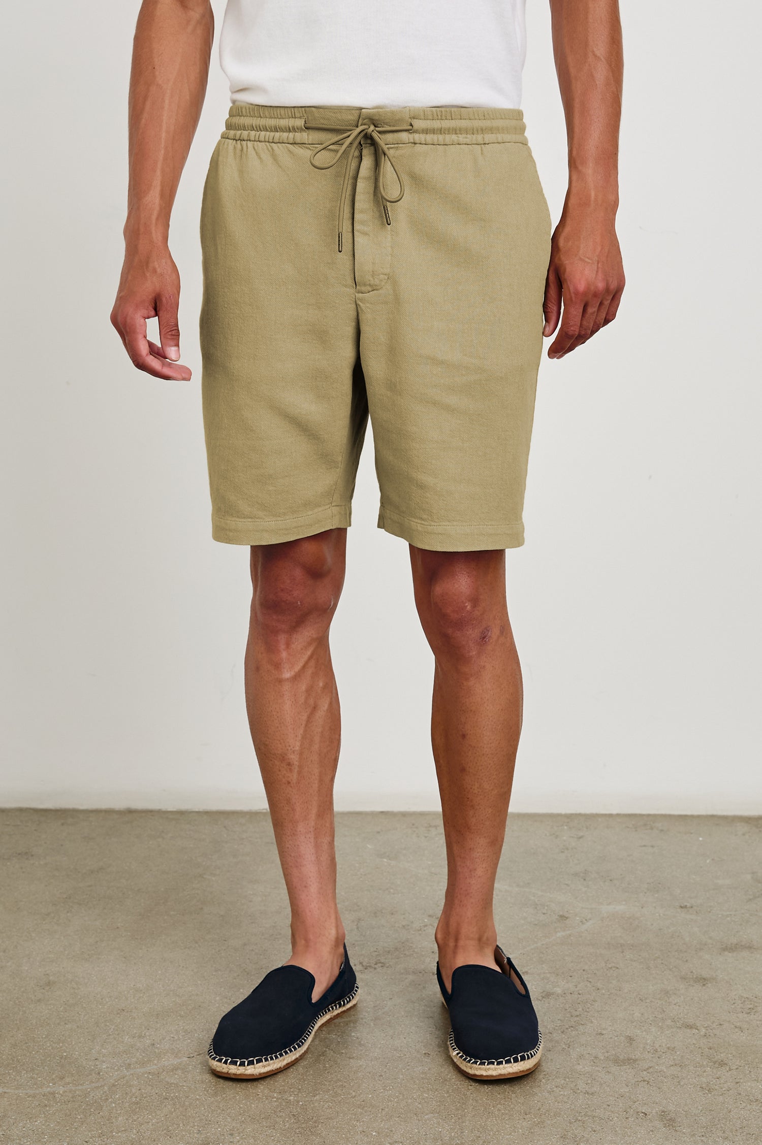 Archer long length cotton short with adjustable drawstring and front button closure in True Khaki - front view on model