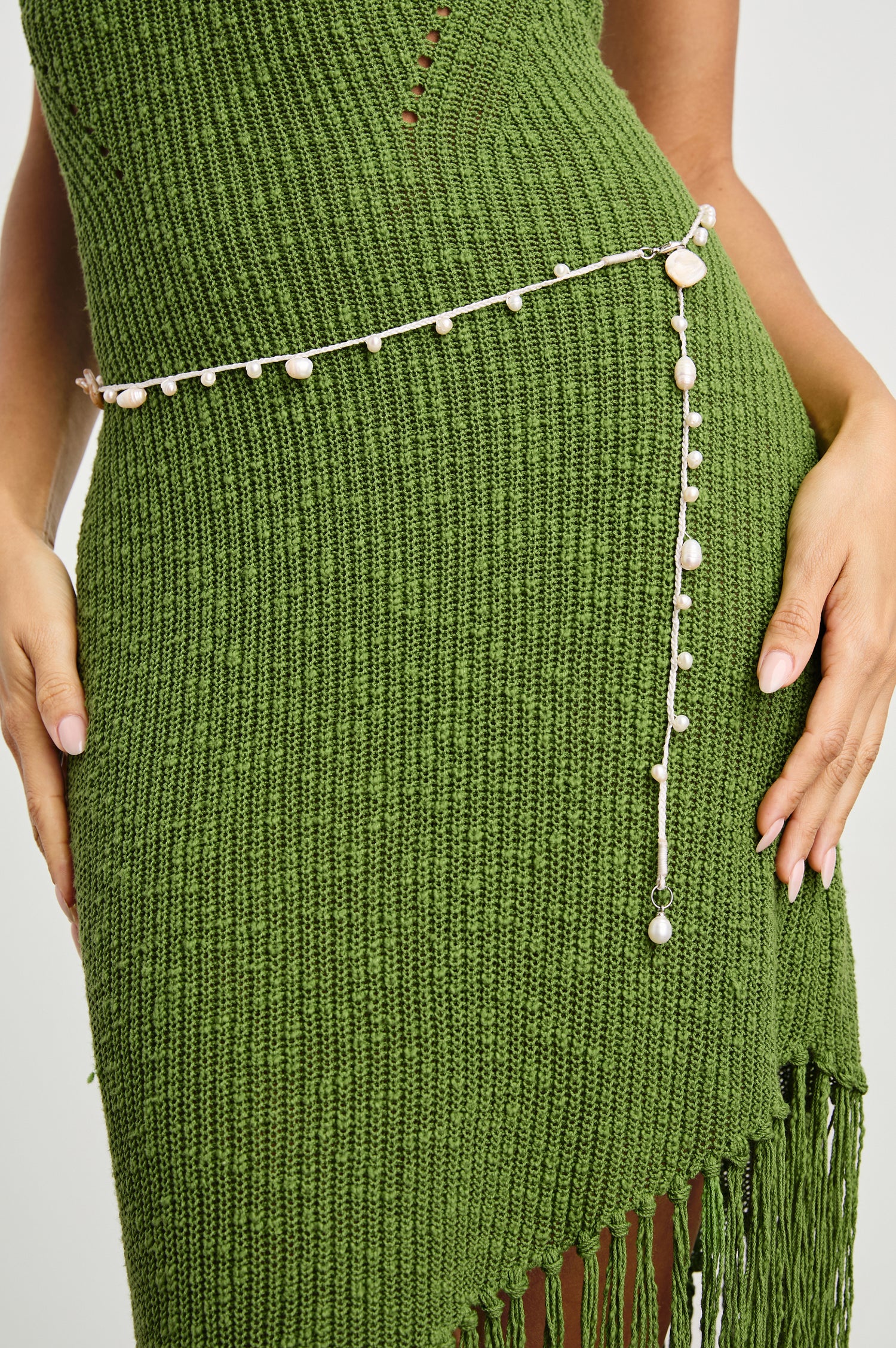 Ariel Cotton Belt with Small Shells Spaced along the Entire Belt and a Dangling End in Ivory Natural Shell Colorway - Front View Featured on Model 