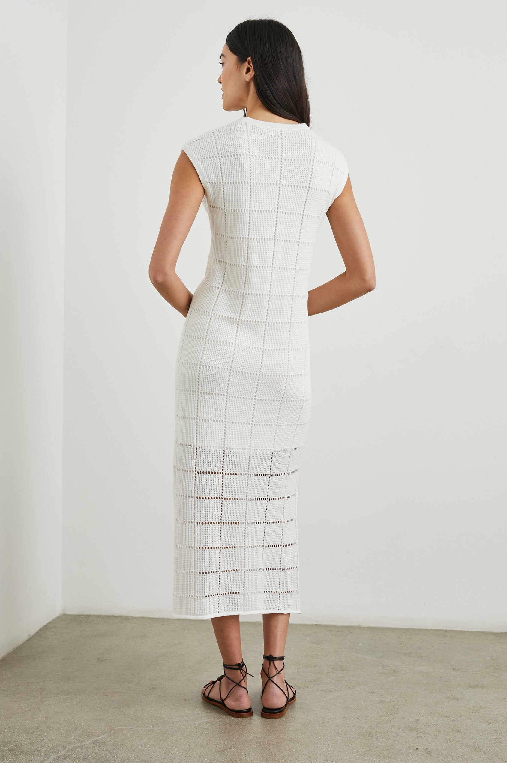 Ashley Short-Sleeve, Open Knit Midi Dress with Cap Sleeves, a V Neck Placket and a Side Slit in White Colorway - Back Full Body View Featured on Model 
