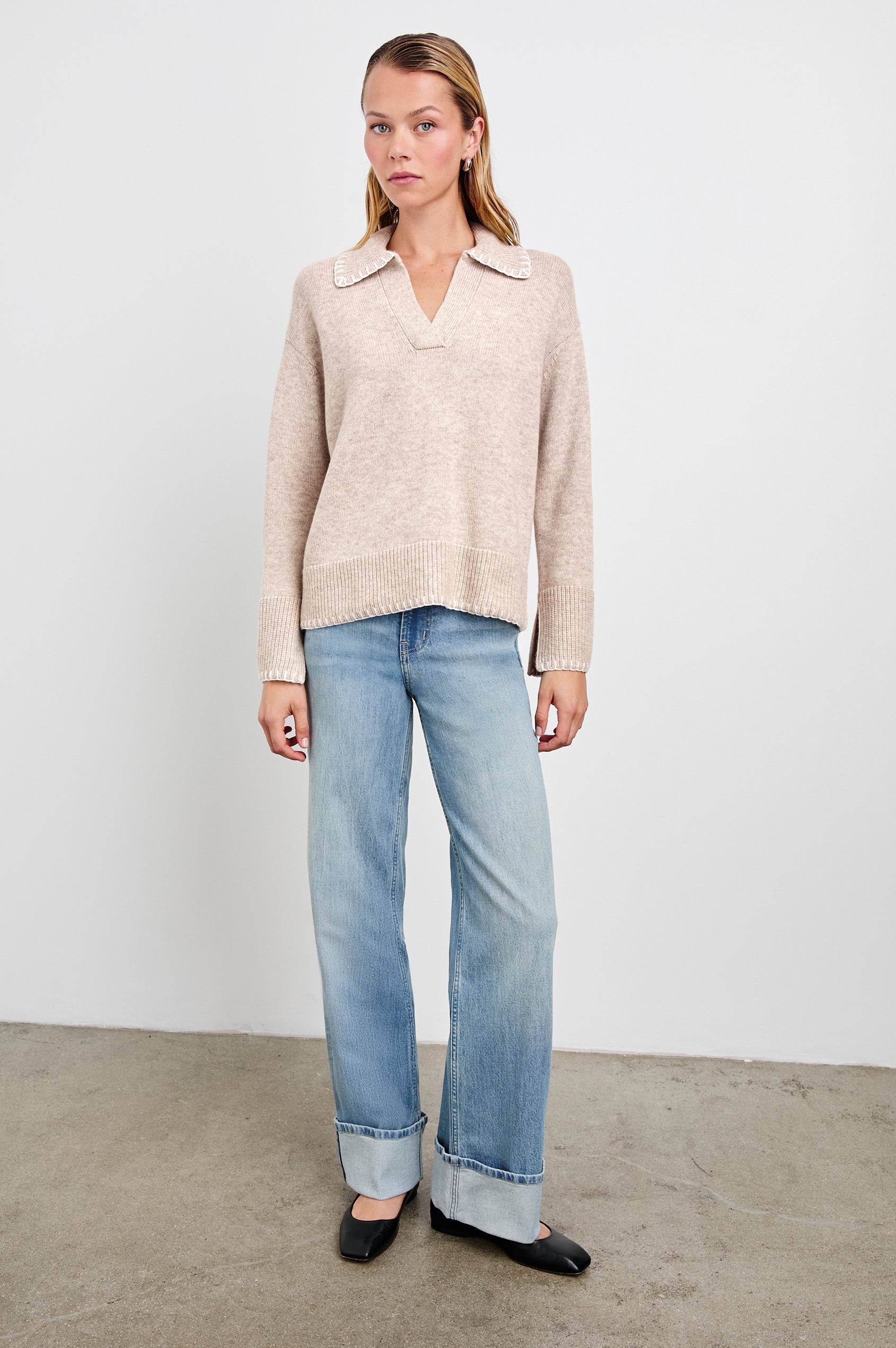 Athena Long-Sleeve Sweater with a Flat Collar V Neckline, Ribbed Cuffs and Hem and Stitching at the Cuffs and Hem in Oat Colorway - Front Full Body View Featured on Model 