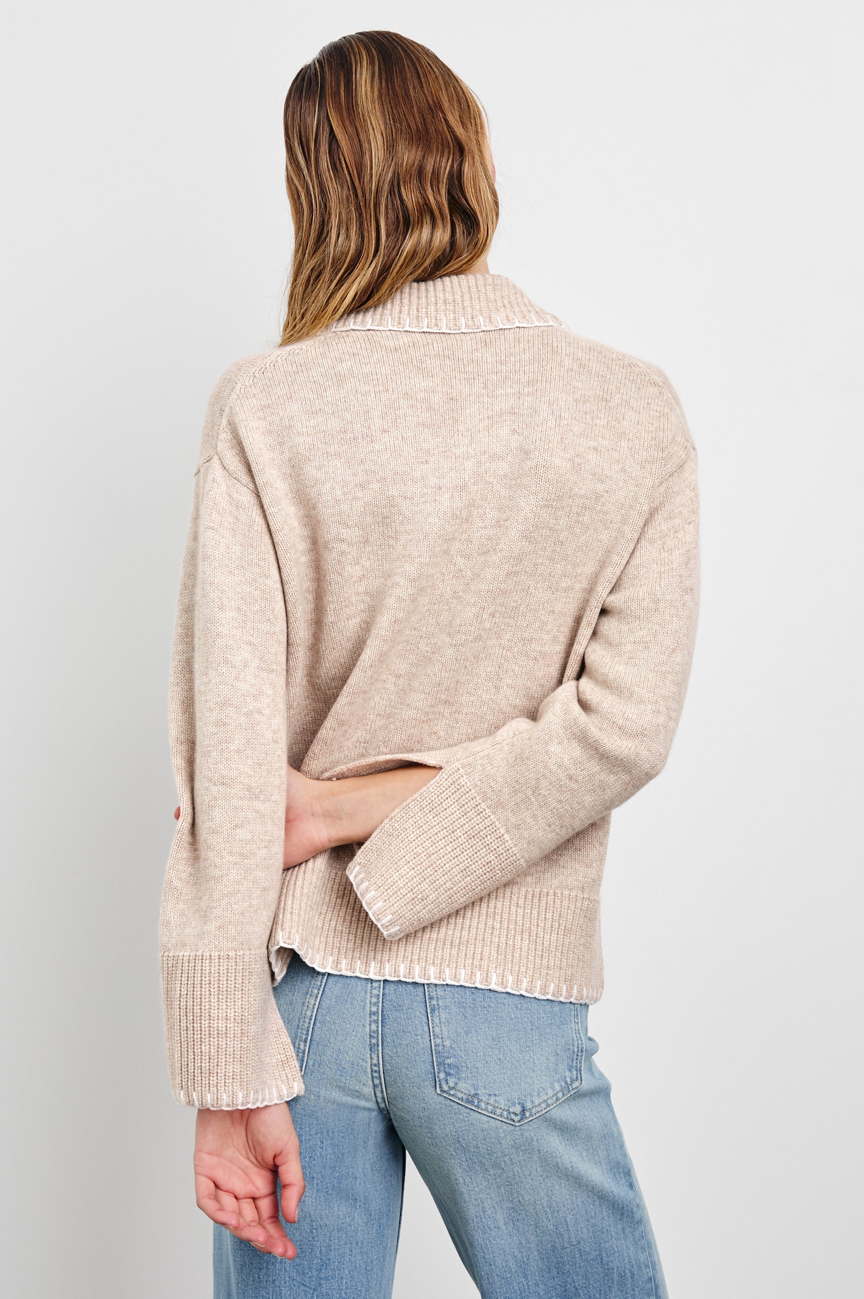 Athena Long-Sleeve Sweater with a Flat Collar V Neckline, Ribbed Cuffs and Hem and Stitching at the Cuffs and Hem in Oat Colorway - Back View Featured on Model 
