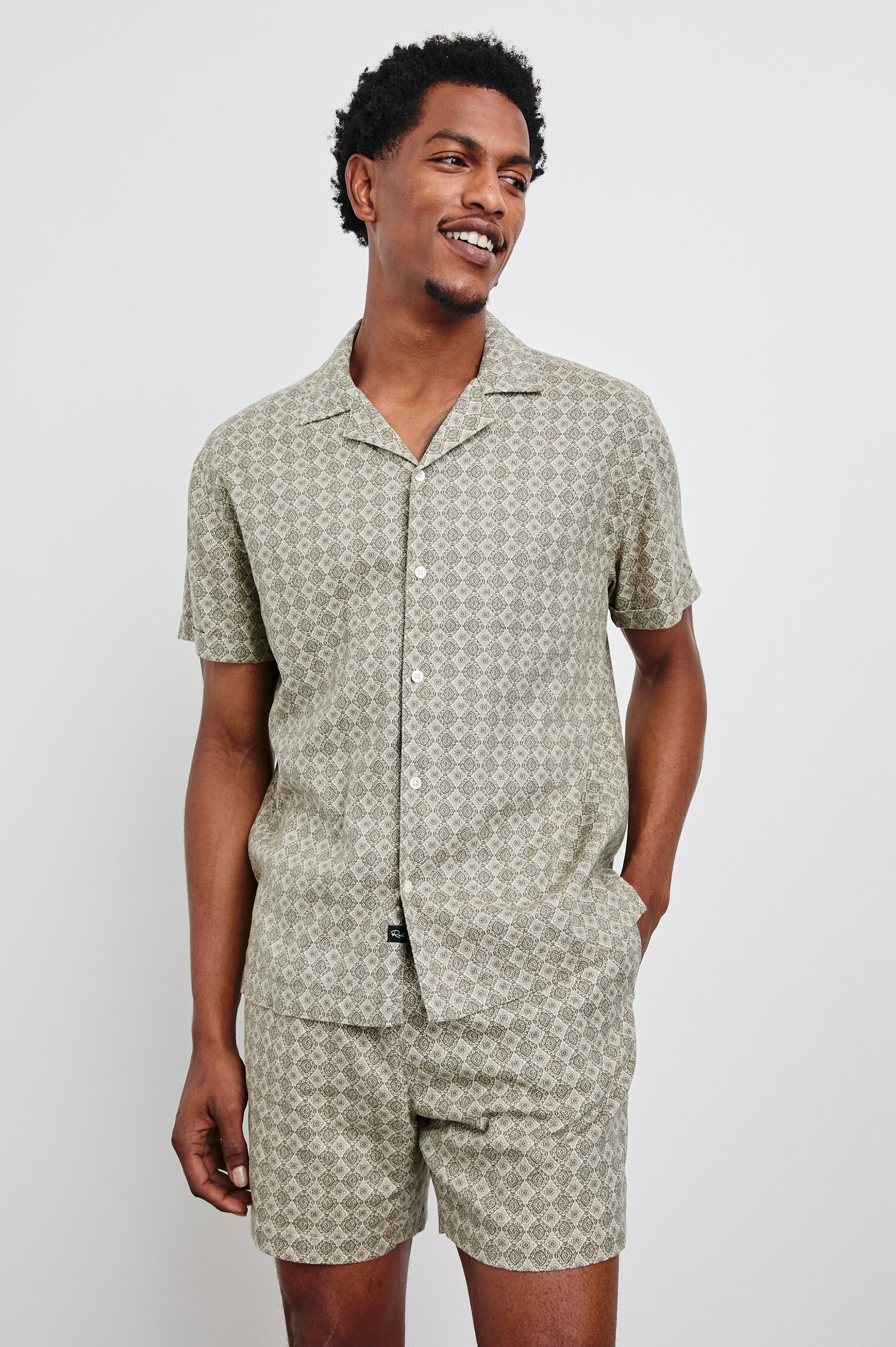 Atlas short sleeve linen blend button up shirt in Diamond Oat Olive art deco pattern - front view on model with matching shorts