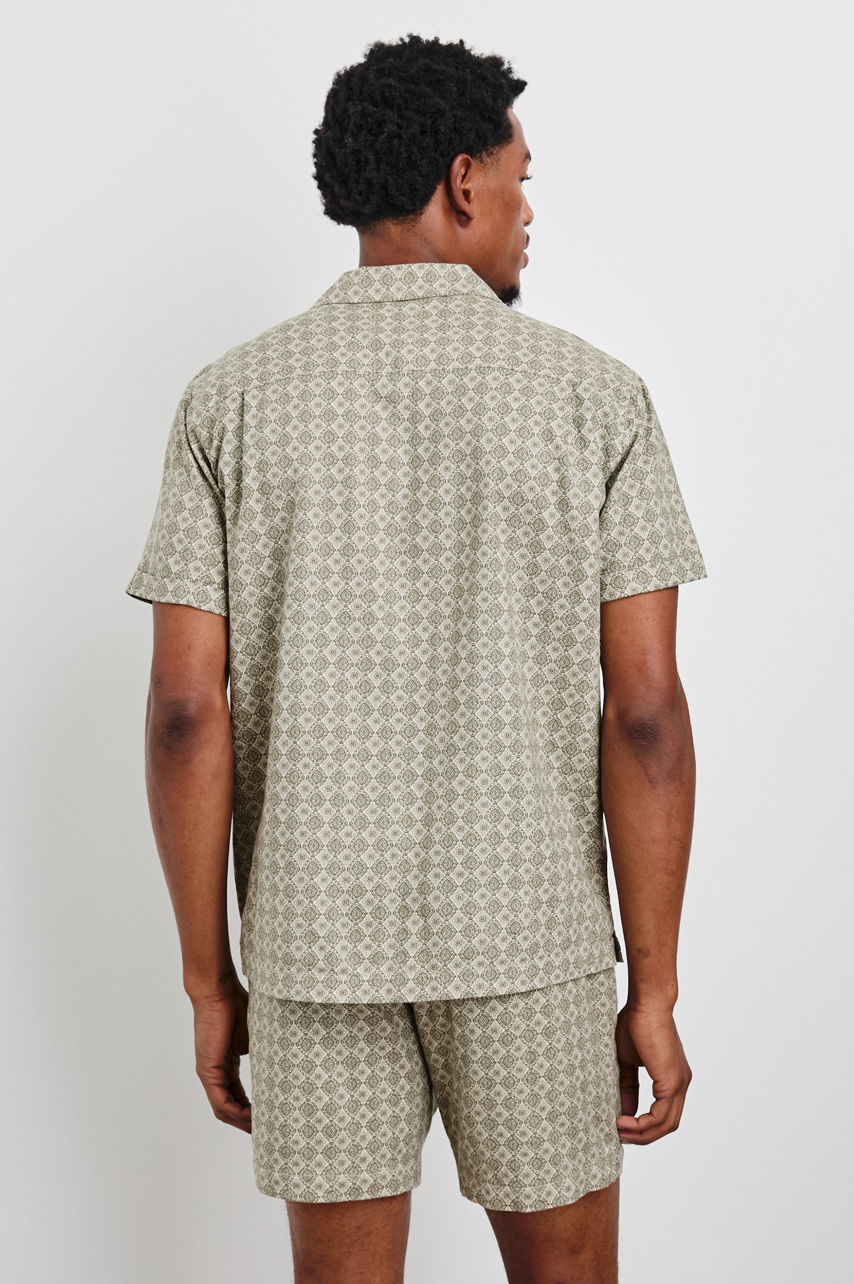 Atlas short sleeve linen blend button up shirt in Diamond Oat Olive art deco pattern - back view on model