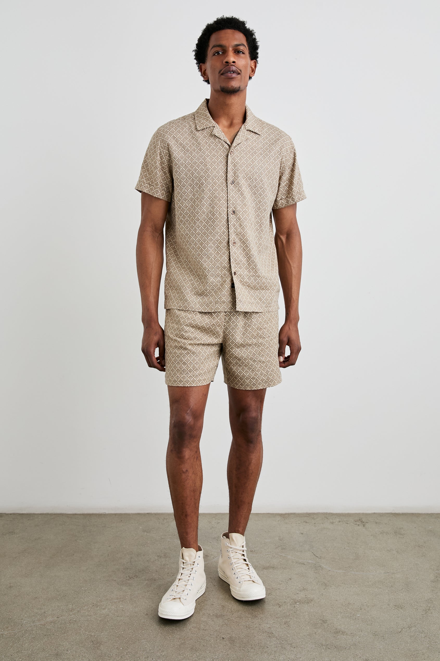 Atlas Short-Sleeve Button Up in Ikat Oat Colorway, with a diamond pattern in browns - Front Full Body View Featured on Model