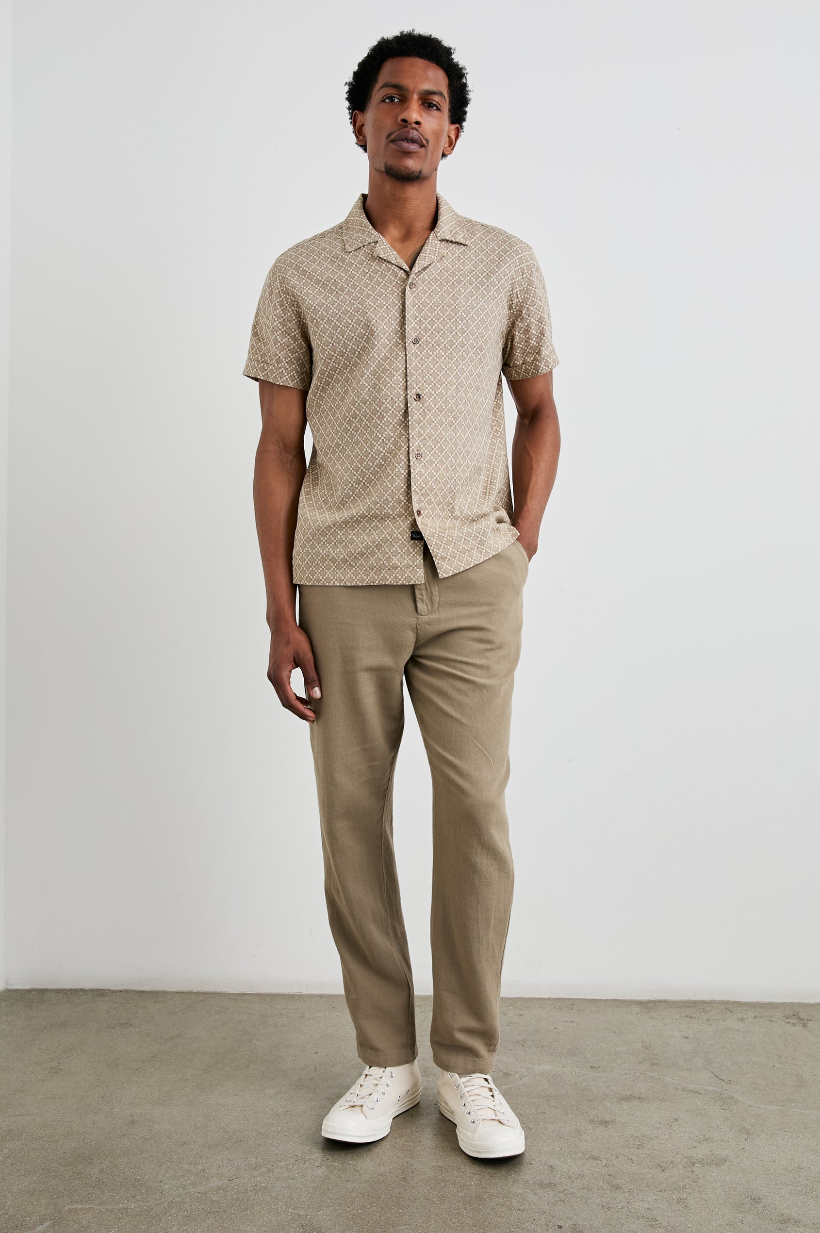 Atlas Short-Sleeve Button Up in Ikat Oat Colorway, with a diamond pattern in browns - Front Full Body View Featured on Model