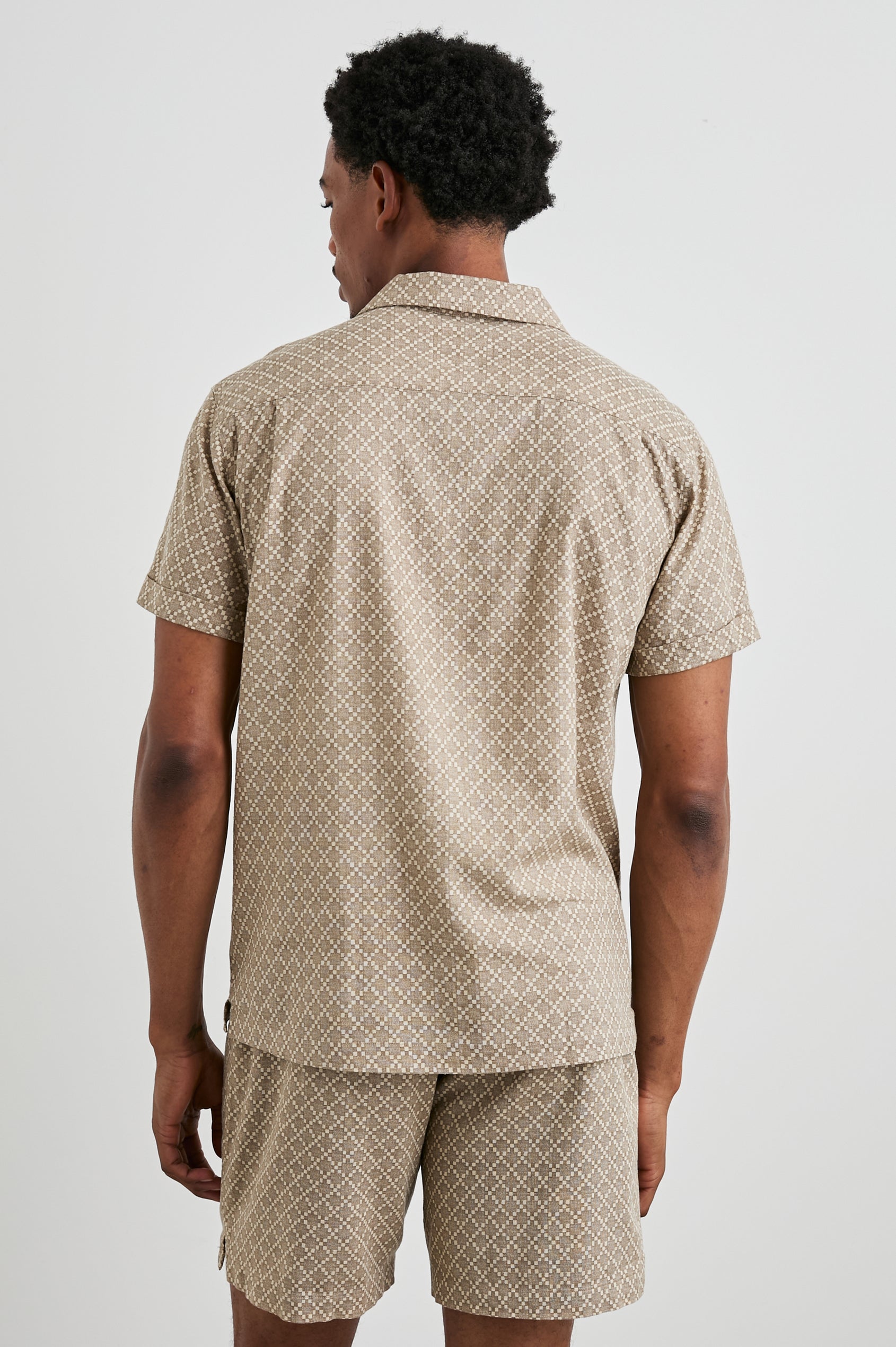Atlas Short-Sleeve Button Up in Ikat Oat Colorway, with a diamond pattern in browns - Back View Featured on Model