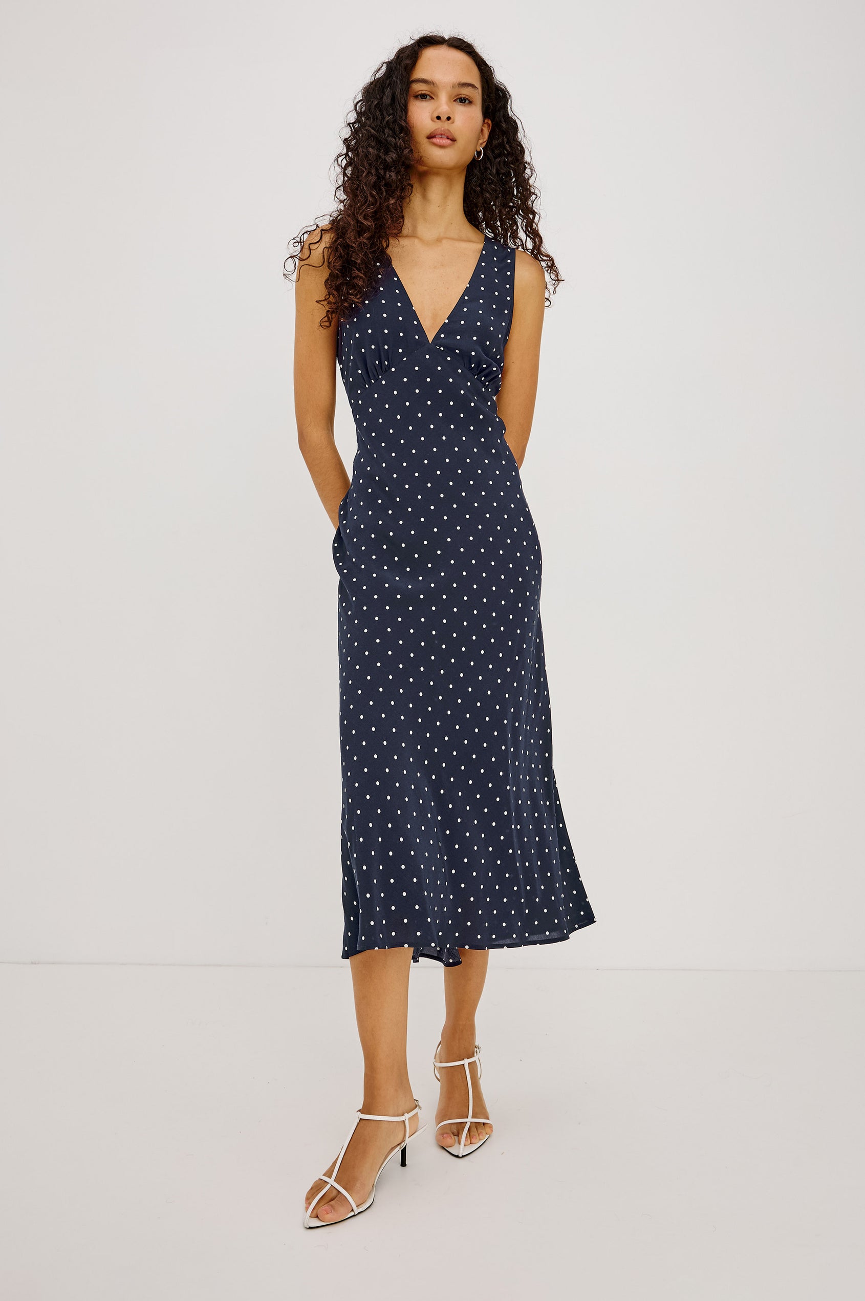 Audrina Midi Dress in Crepe Blend Bias Cut With Plunging V-Neckline in Navy Polka Dots Colorway - Full Body Front View Featured on Model