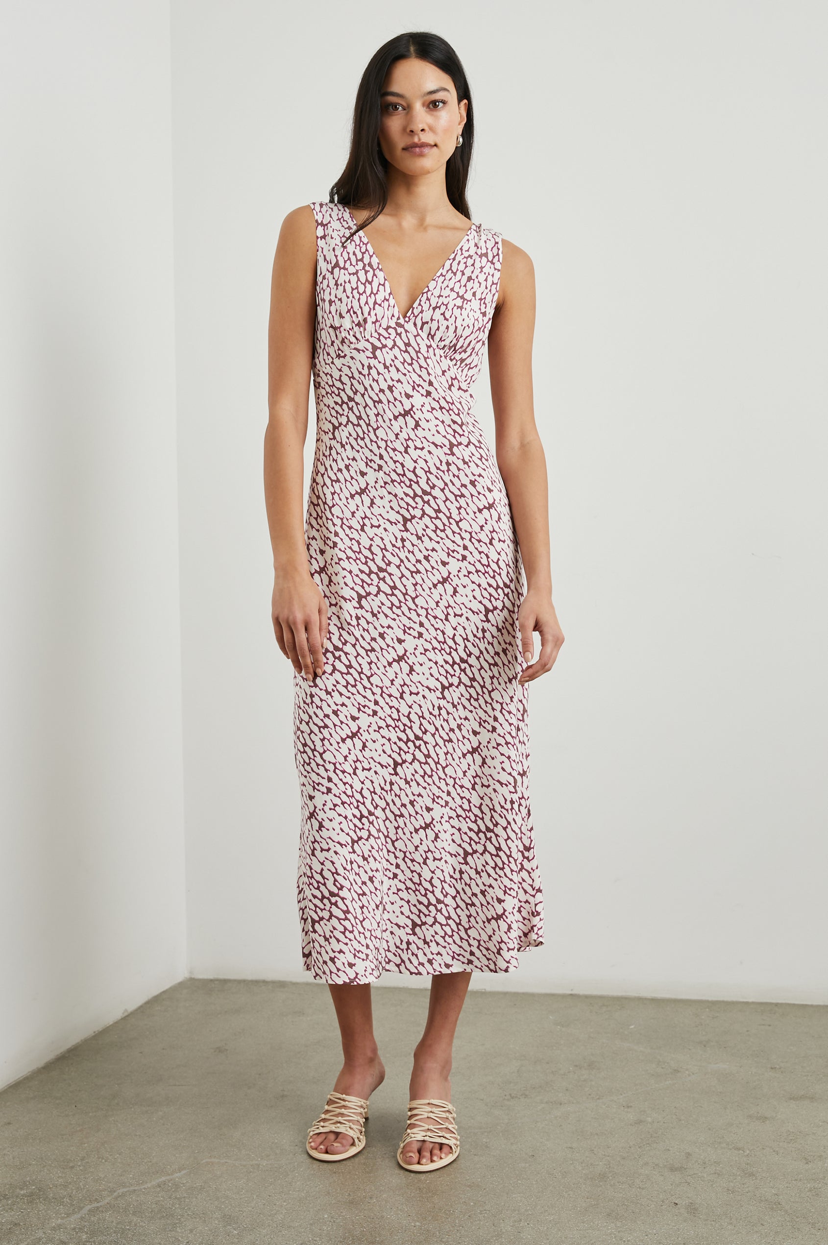 Audrina Sleeveless Midi Dress with Wide Shoulder Straps, a Deep V Neck and V-Back, and an Empire Waist in Pink Static Leopard Colorway, a white spot pattern on dark pink - Front Full Body View Featured on Model 