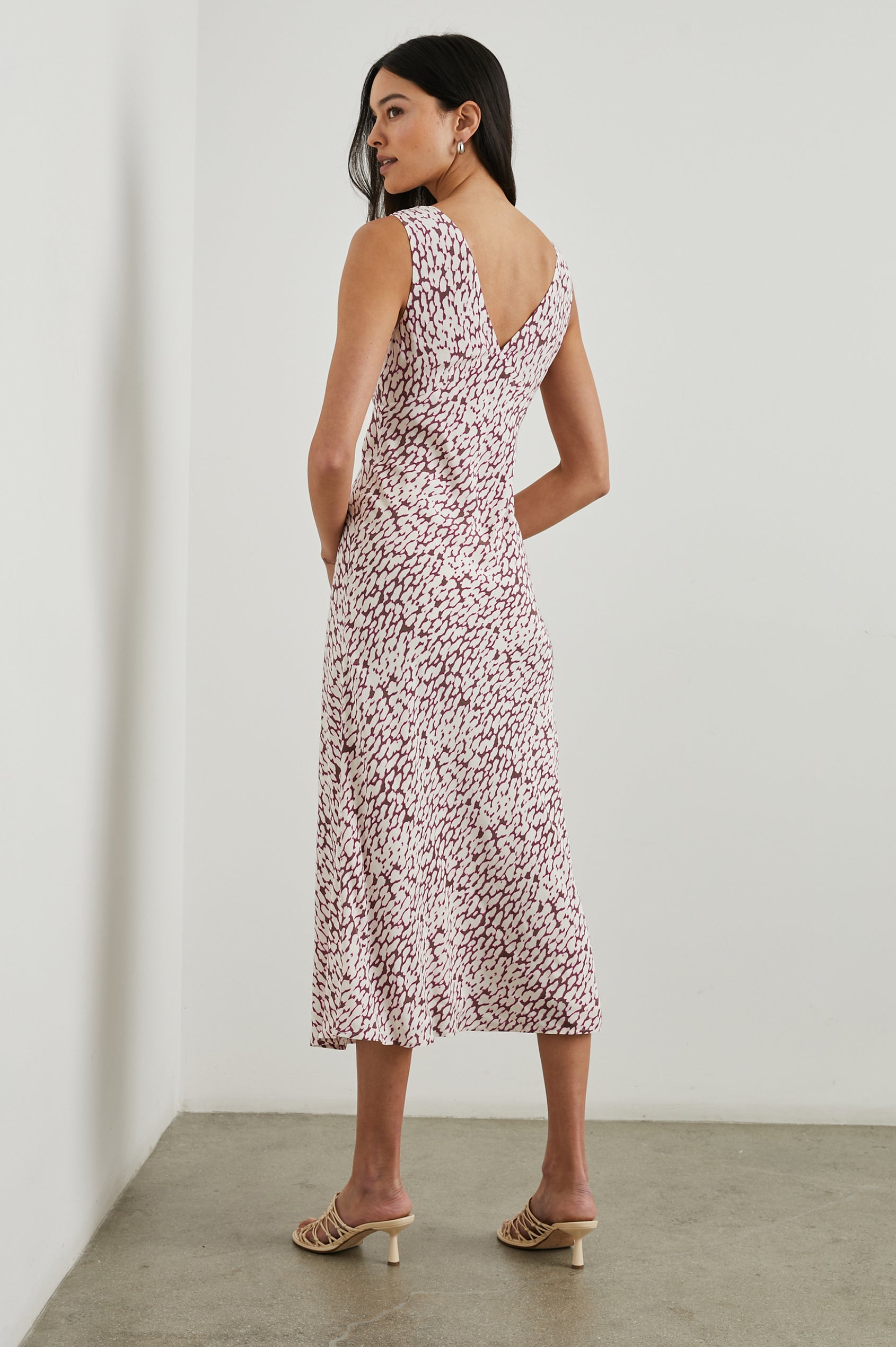 Audrina Sleeveless Midi Dress with Wide Shoulder Straps, a Deep V Neck and V-Back, and an Empire Waist in Pink Static Leopard Colorway, a white spot pattern on dark pink - Back Full Body View Featured on Model 