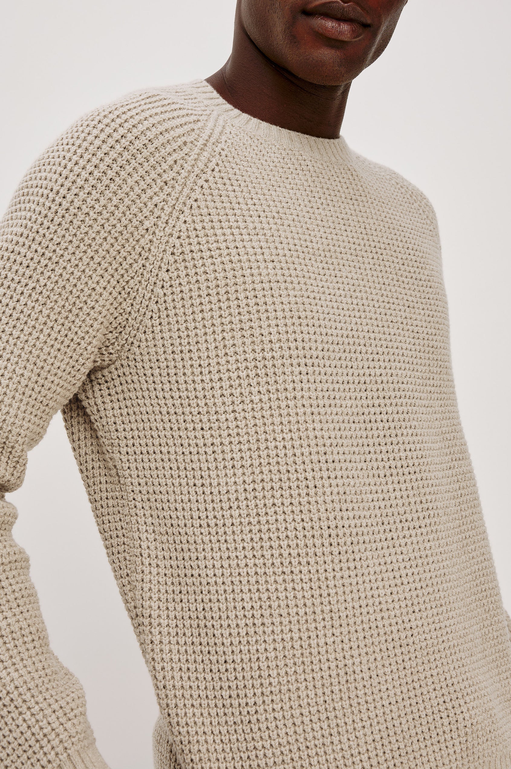 Augustus Sweater in Midweight Cotton-Linen Knit With Thermal Stitch, Textured Bouclé Finish, Raglan Long Sleeves, and Ribbed Trim in Vellum Colorway - Upper Body Close Up View Featured on Model