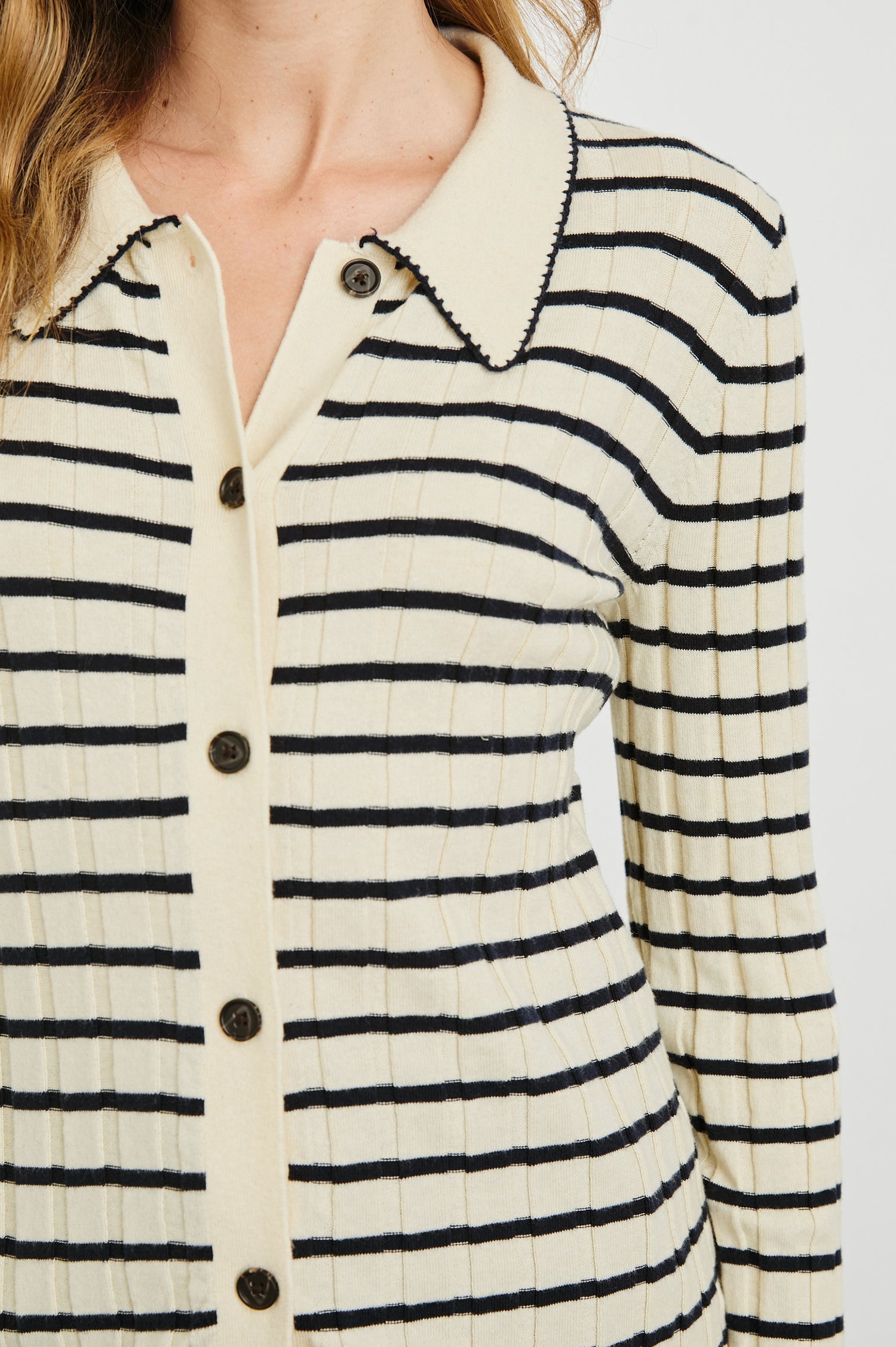 Aurelia Long-Sleeve, Wide Ribbed Top with Buttons Down the Front, a Collar and  Scalloped Stitching at the Collar and Cuffs in Ivory Navy Stripe Colorway - Horizontal Stripes - Front View Featured on Model 