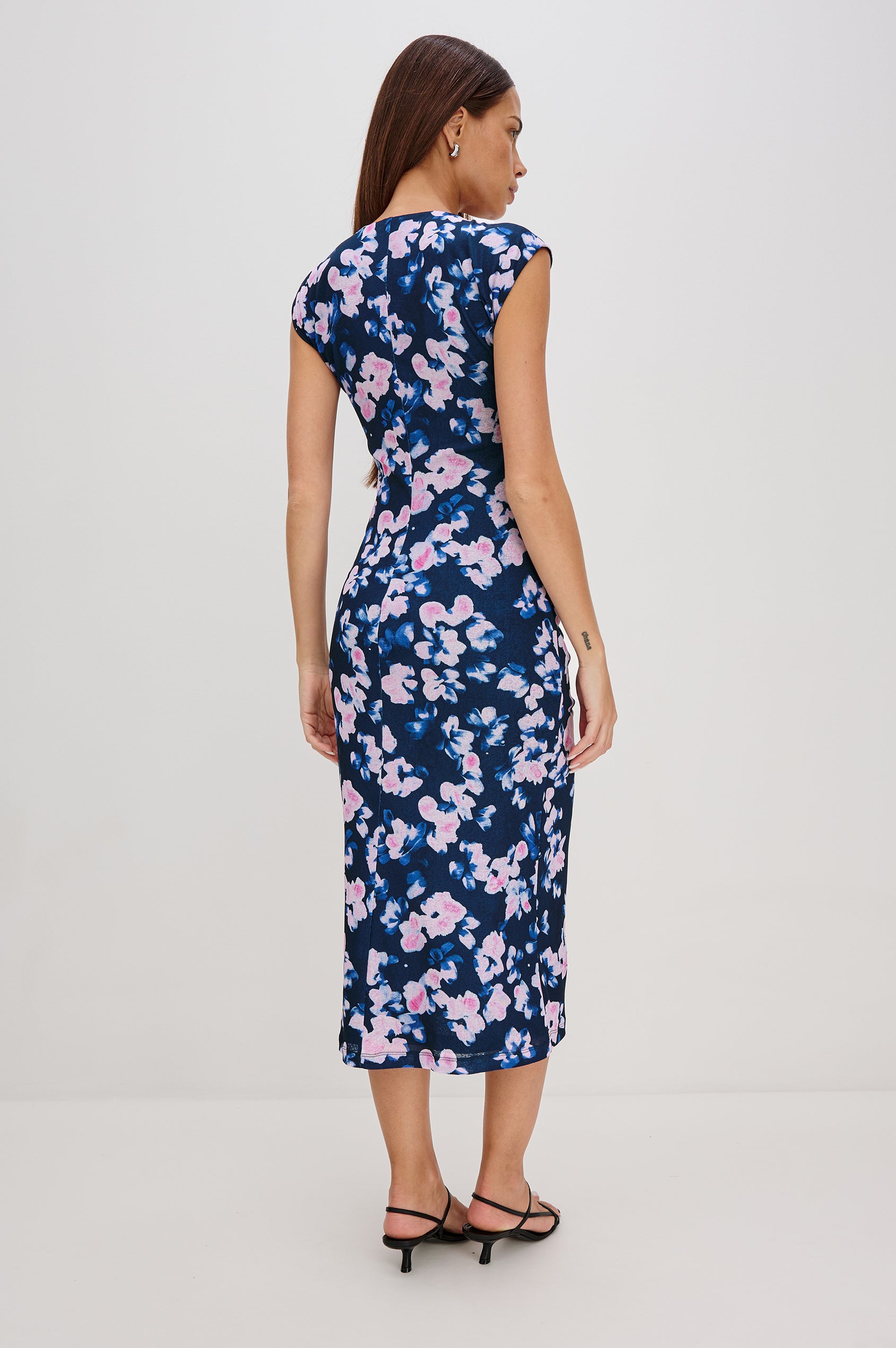 Auren Midi Dress with Cap Sleeves, a Deep V Neck, a Mid-Thigh Side Slit and Ruching from the V Neck to the Slit with a Drawcord at the Slit in Midnight Peony Colorway - Back View Featured on Model