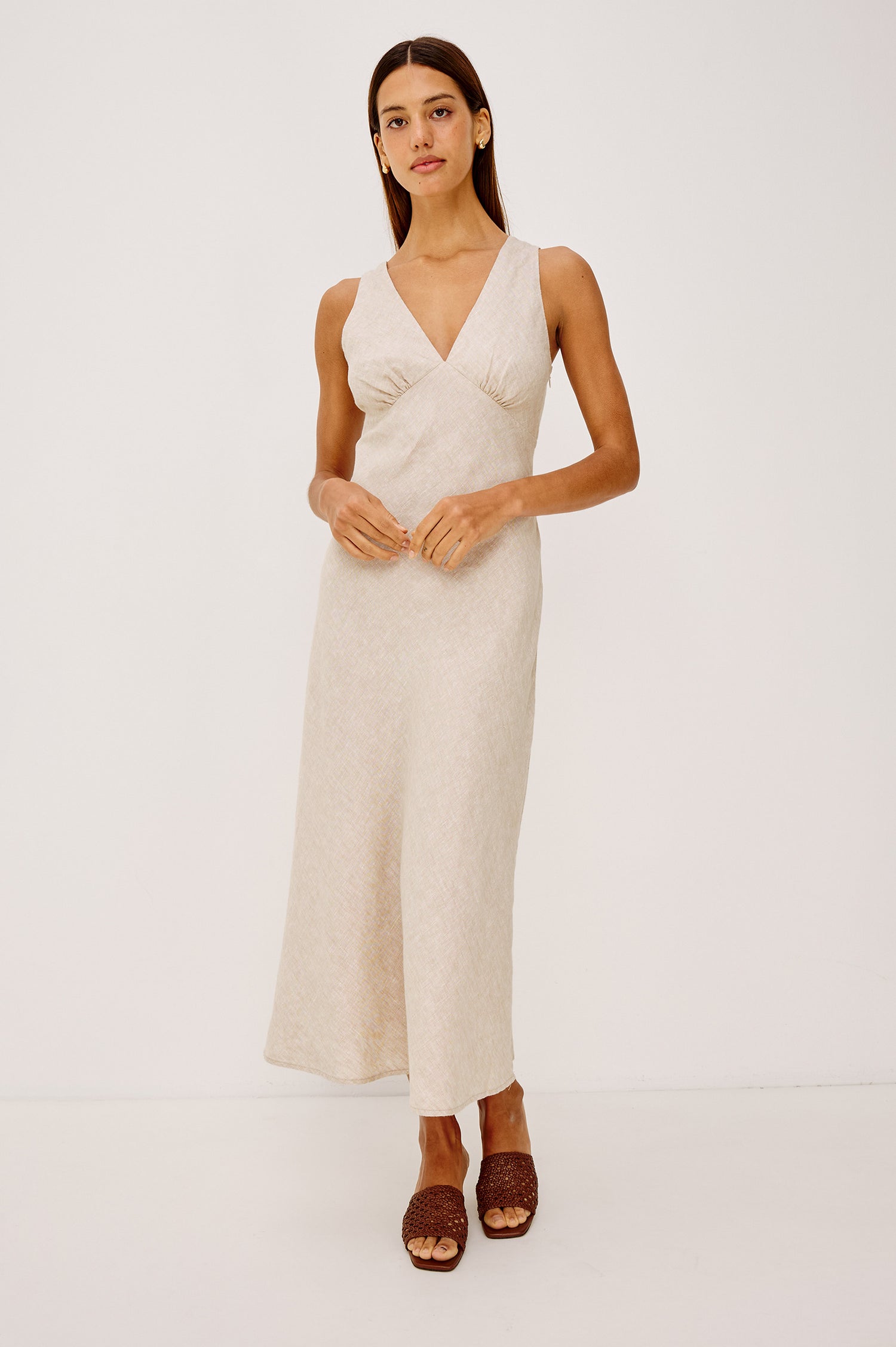 Avianna Midi Dress in Linen With Sleeveless Bias Cut, Plunging V-Neckline, Empire Waist, and Hidden Side Zip in Heathered Flax Colorway - Full Body Front View Featured on Model