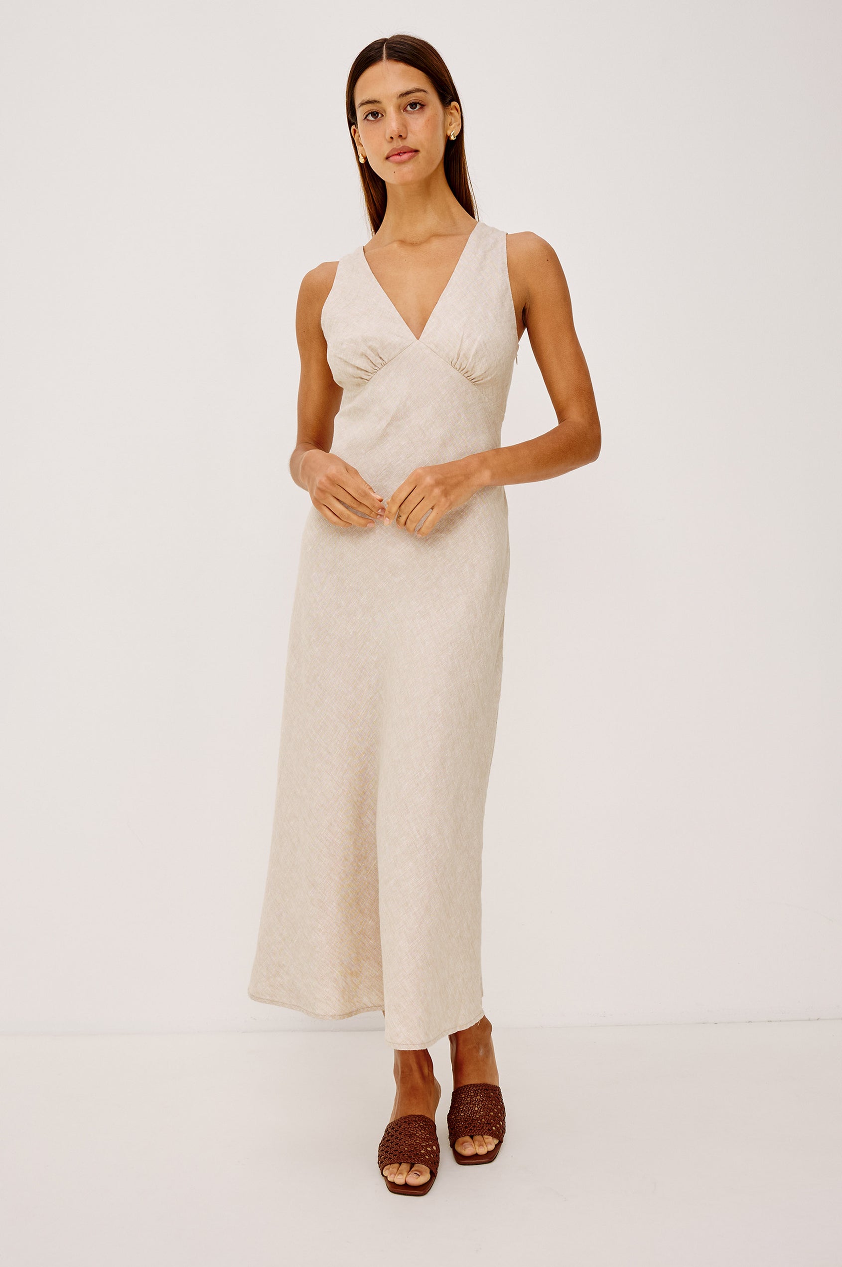 Avianna Midi Dress in Linen With Sleeveless Bias Cut, Plunging V-Neckline, Empire Waist, and Hidden Side Zip in Heathered Flax Colorway - Full Body Front View Featured on Model