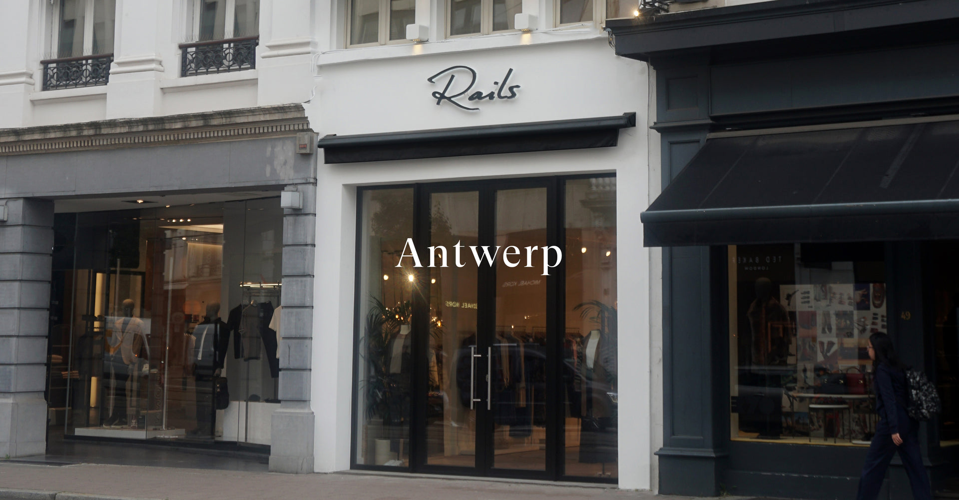 OUTSIDE OF ANTWERP STORES SHOWING MAIN ENTRANCE (TWO LARGE GLASS DOORS)