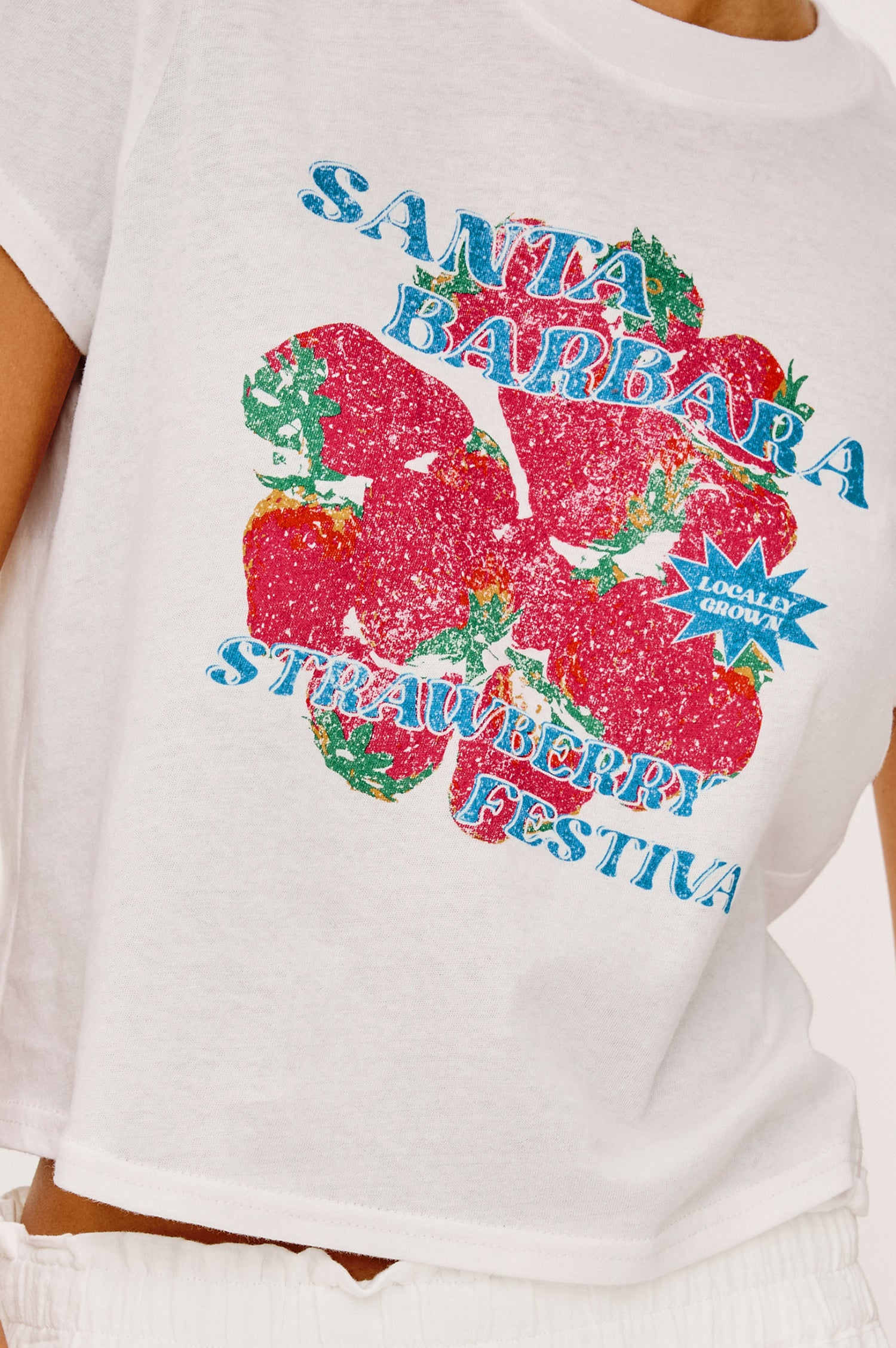 Baby Tee in Cotton With Crew Neckline, Short Sleeves, Boxy, Cropped FIt, and Graphic Print at Front in Santa Barbara Strawberry Festival Colorway - Upper Body Front View Featured on Model