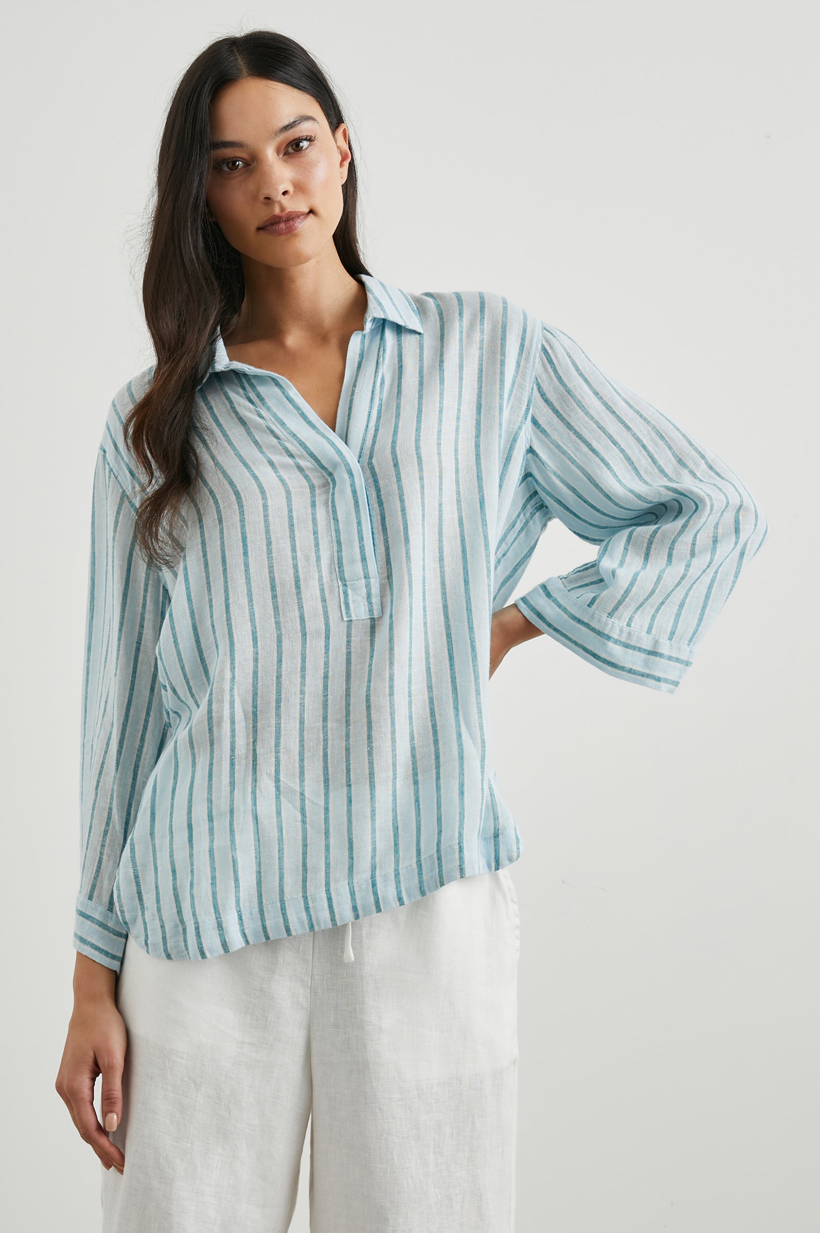 Banks Long-Sleeve Top with Wide Sleeves, a Collar, and a V neck with a Half-Sealed Placket in Cambria Stripe Colorway, with Vertical Stripes in Blue and Light Blue - Front View Featured on Model
