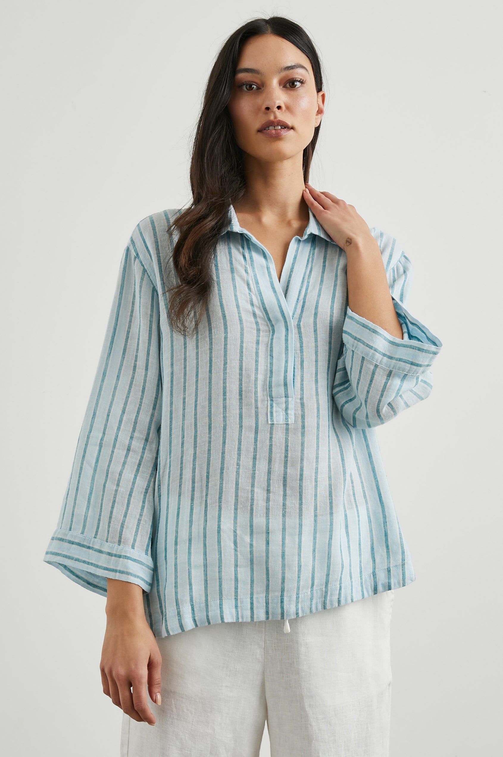 Banks Long-Sleeve Top with Wide Sleeves, a Collar, and a V neck with a Half-Sealed Placket in Cambria Stripe Colorway, with Vertical Stripes in Blue and Light Blue - Front View Featured on Model