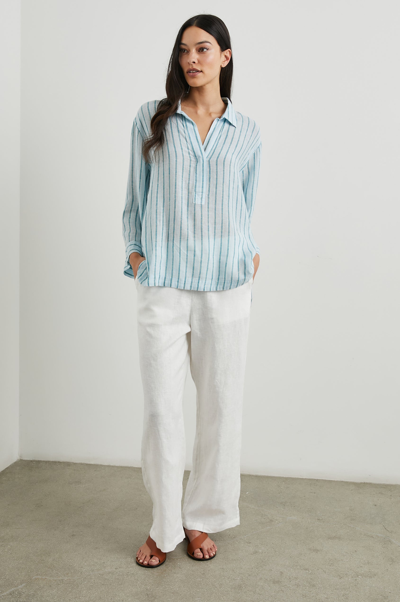 Banks Long-Sleeve Top with Wide Sleeves, a Collar, and a V neck with a Half-Sealed Placket in Cambria Stripe Colorway, with Vertical Stripes in Blue and Light Blue - Front Full Body View Featured on Model