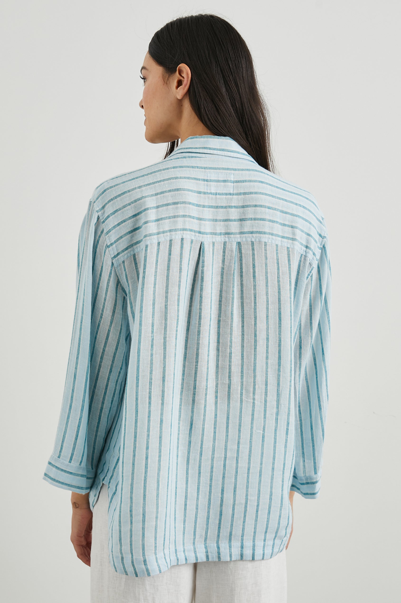 Banks Long-Sleeve Top with Wide Sleeves, a Collar, and a V neck with a Half-Sealed Placket in Cambria Stripe Colorway, with Vertical Stripes in Blue and Light Blue - Back View Featured on Model